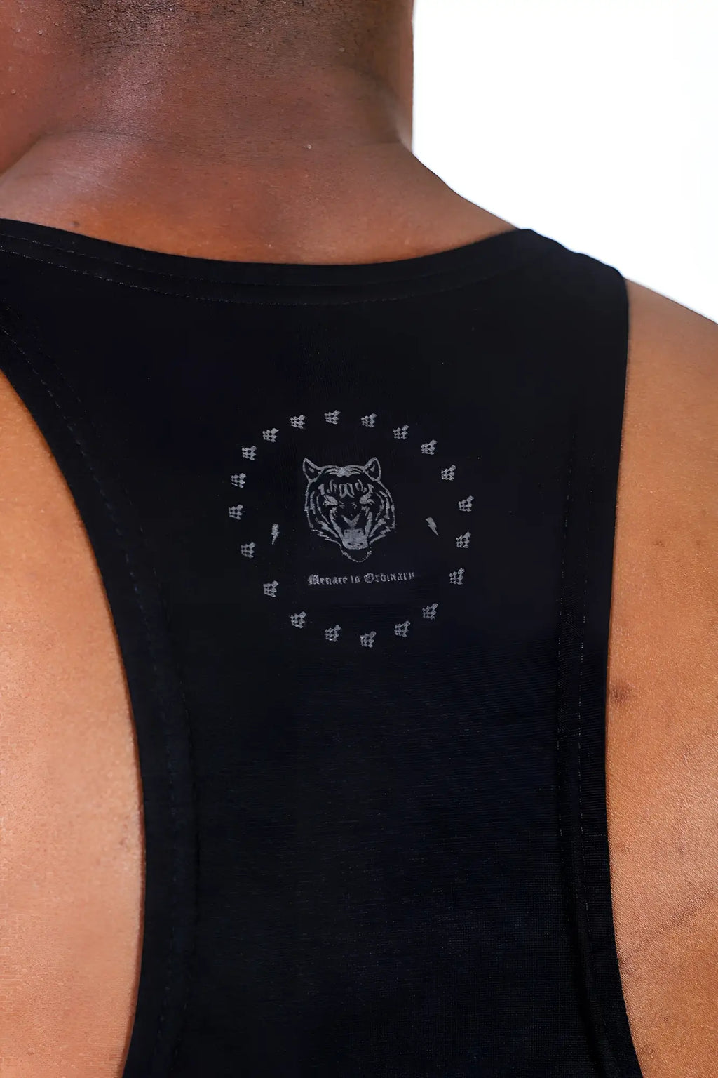 Black racerback tank top with white embroidered tiger head and beater in yourself quote for bodybuilding use
