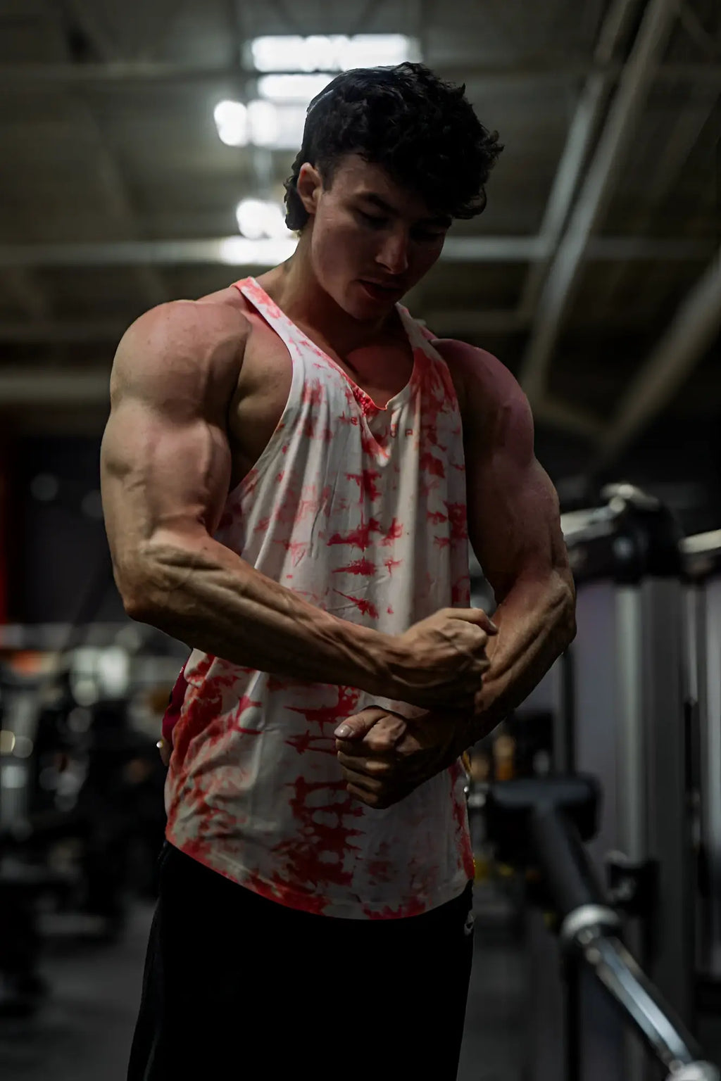 A white and red tie dye classic bodybuilding racerback stringer tank top with a loose athletic fit