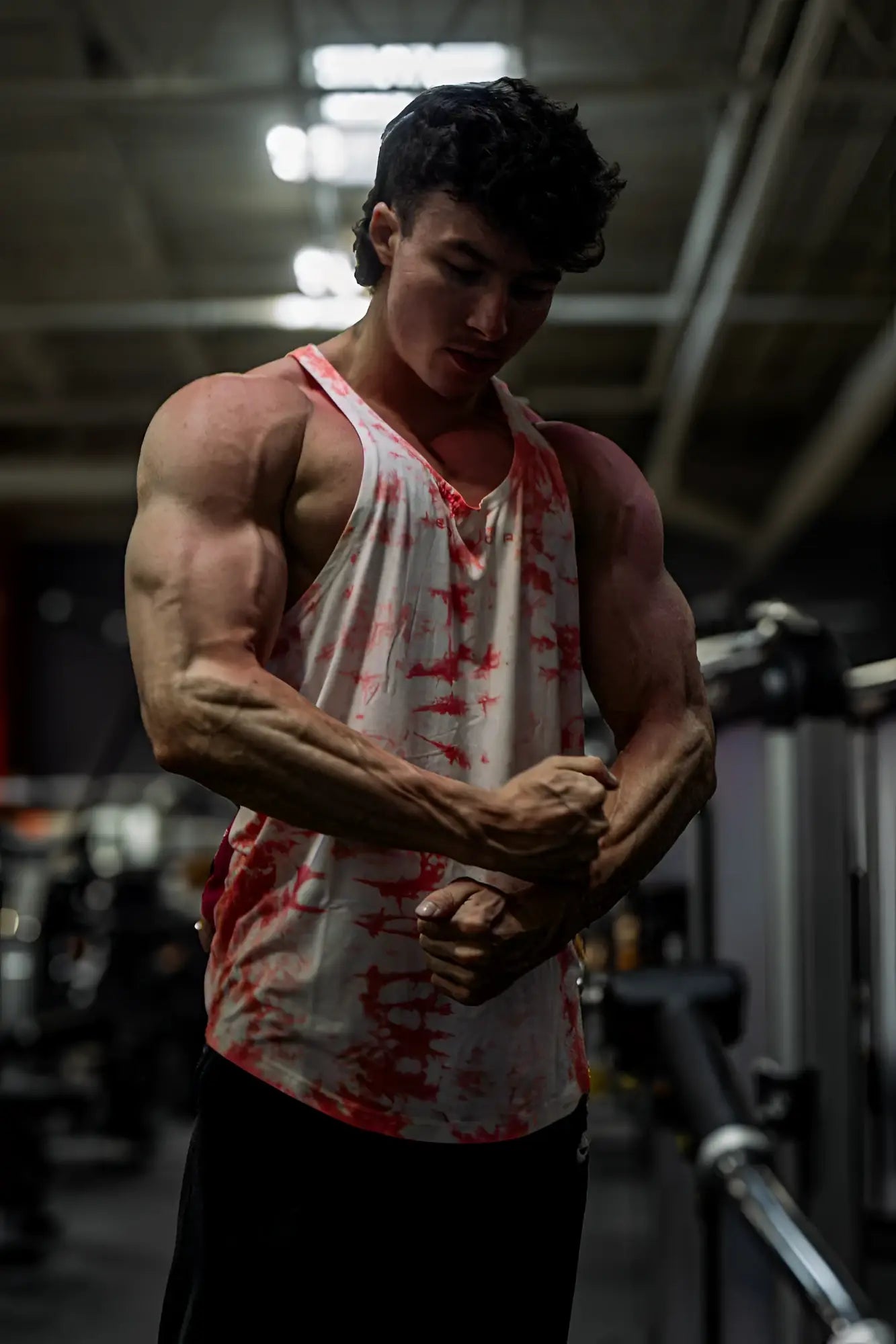 A white and red tie dye classic bodybuilding racerback stringer tank top with a loose athletic fit