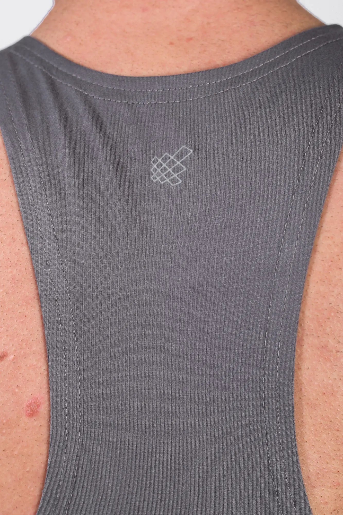 Jed North classic bodybuilding racerback stringer in steel gray featuring a subtle white geometric logo near neckline