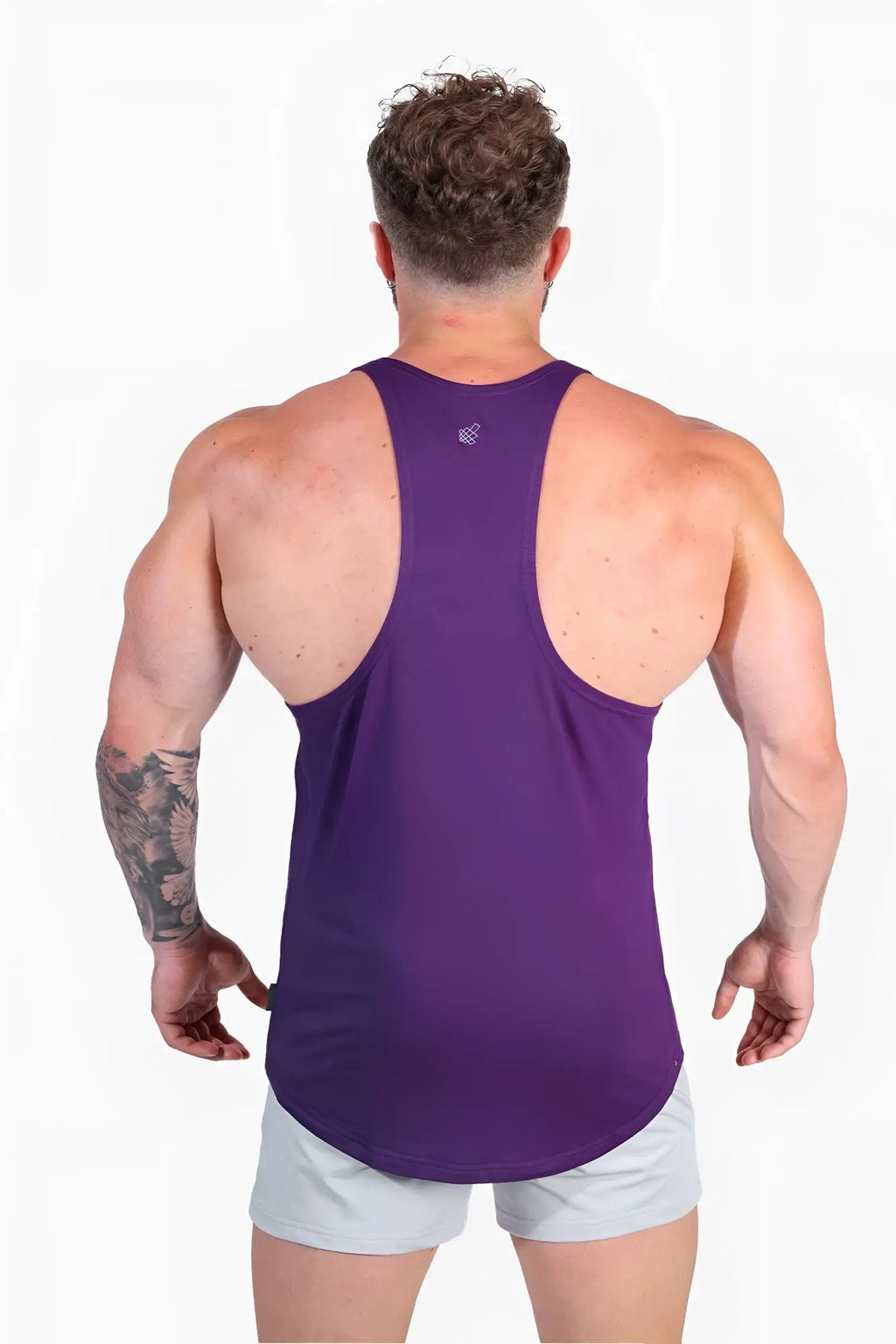 Back view of a violet classic bodybuilding racerback stringer muscle tank top with a small logo on the upper back