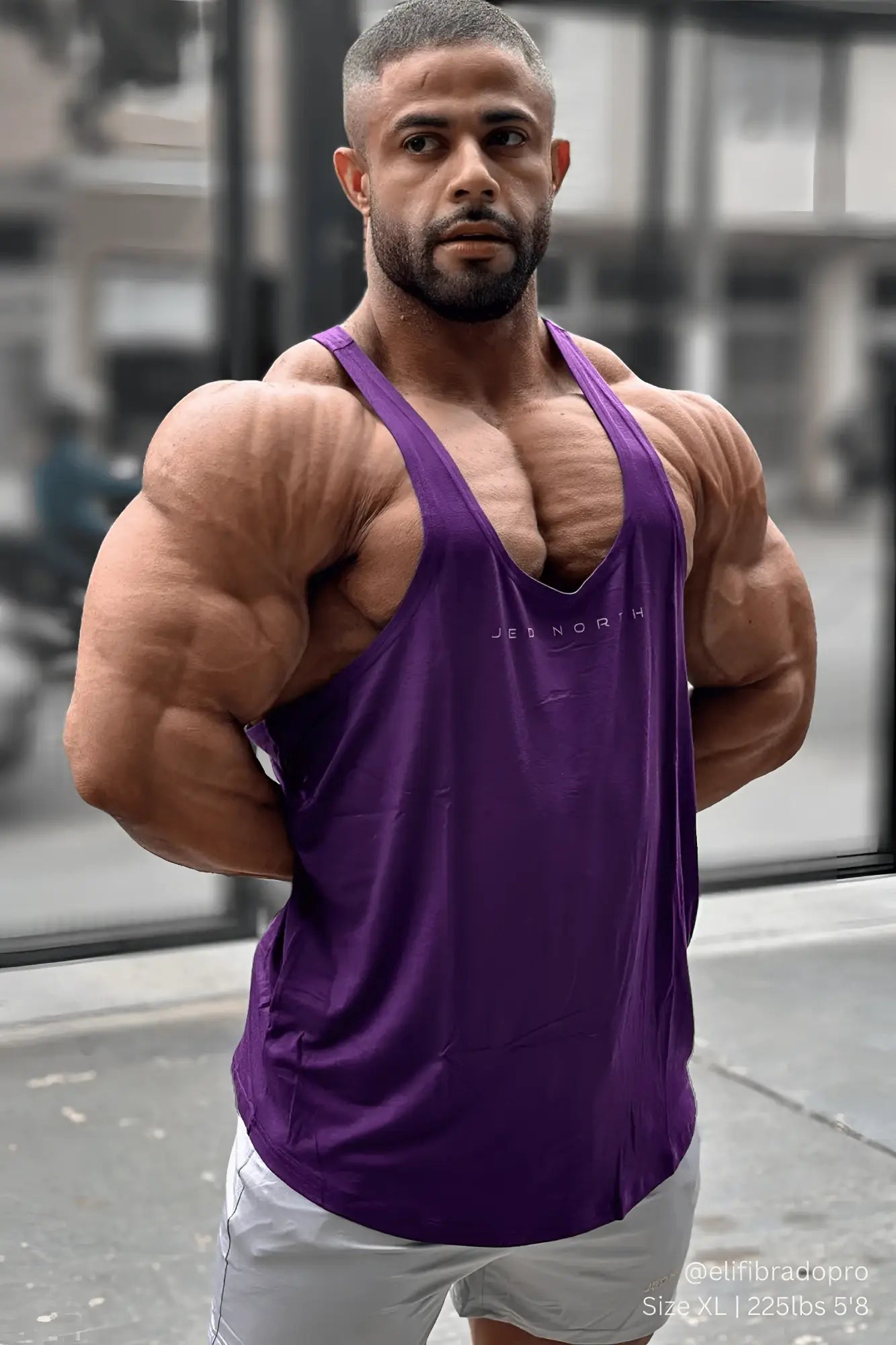 Purple classic bodybuilding racerback stringer tank top with jes north branding across the chest in violet