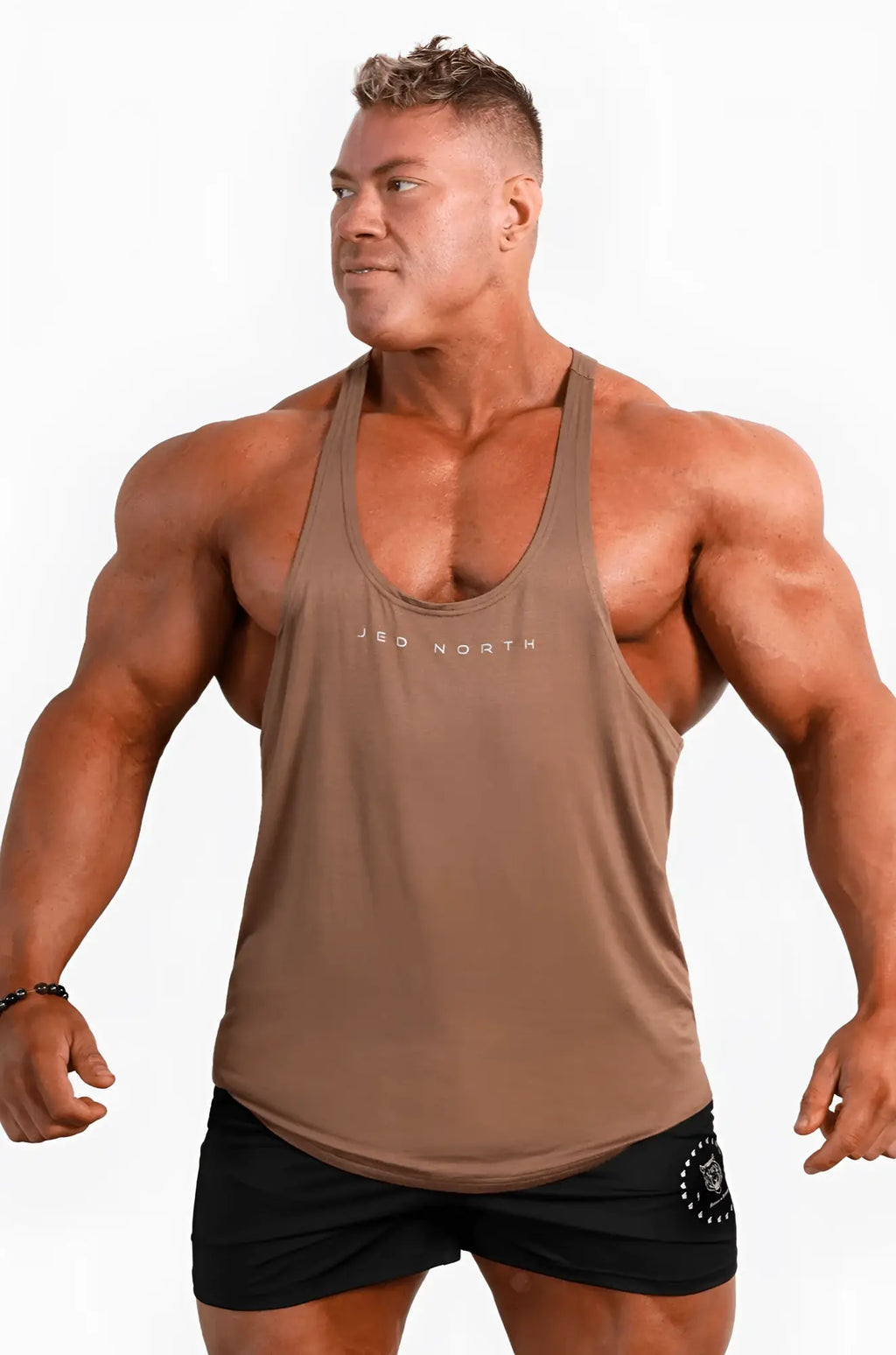 A tan sleeveless tank top with a subtle jbo north logo across the chest from jed north in walnut brown