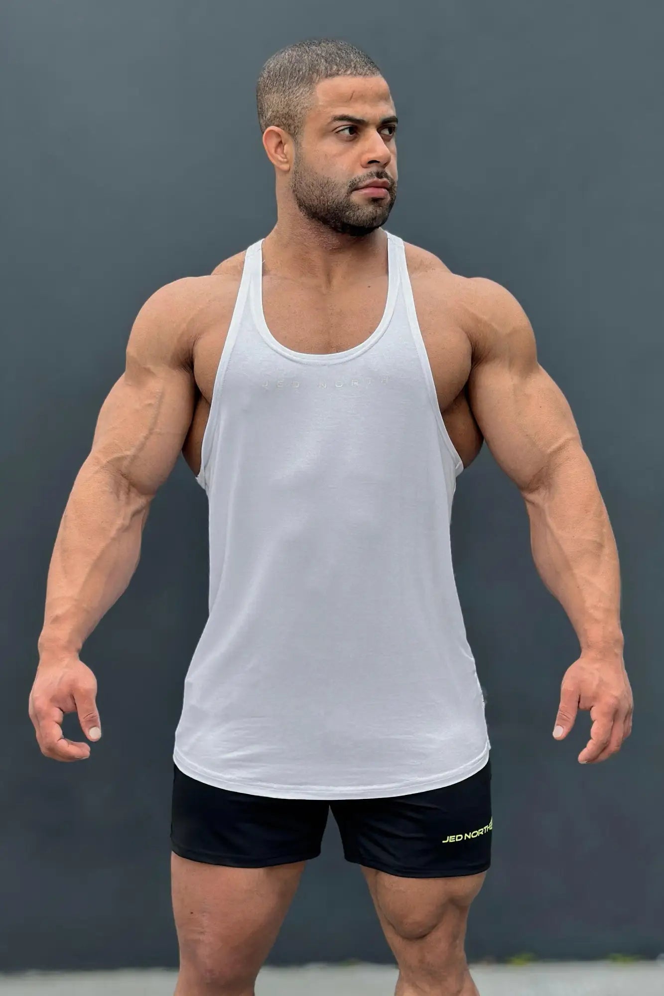 White athletic tank top with simple fitted design from classic bodybuilding racerback stringer collection