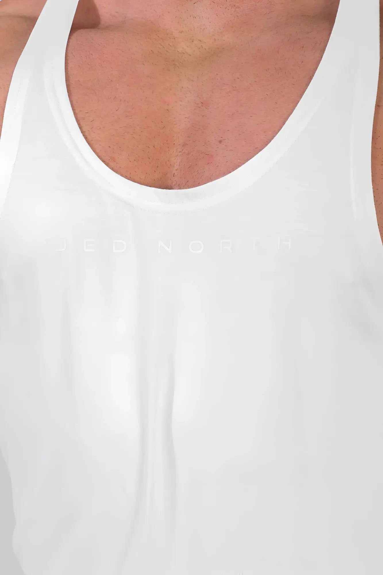 White classic bodybuilding racerback stringer tank top with subtle embossed logo across the chest