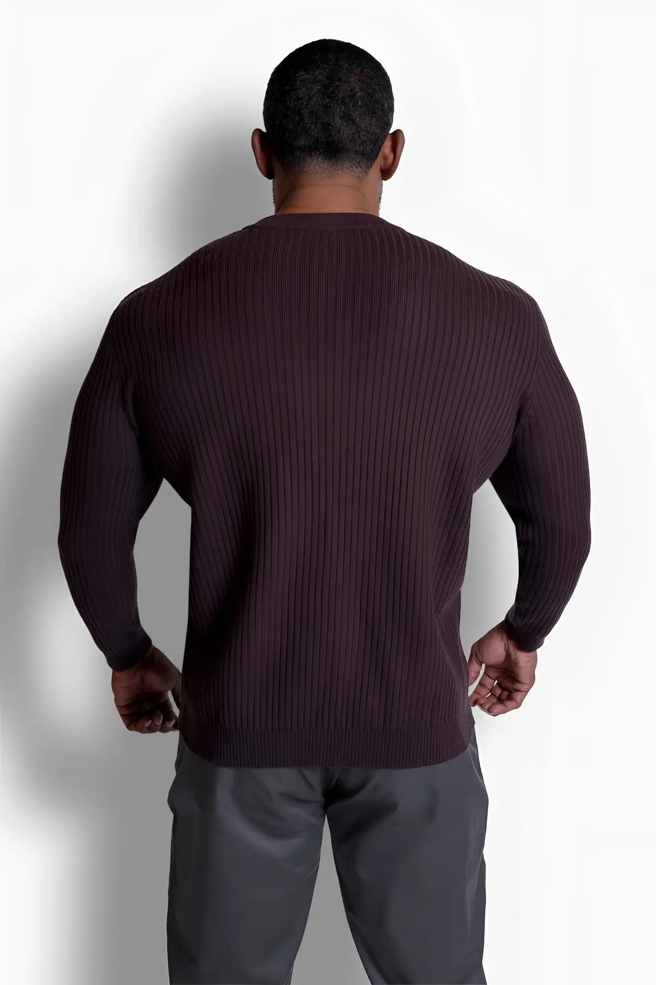 A dark brown ribbed knit classic henley sweater with long sleeves and a crew neckline