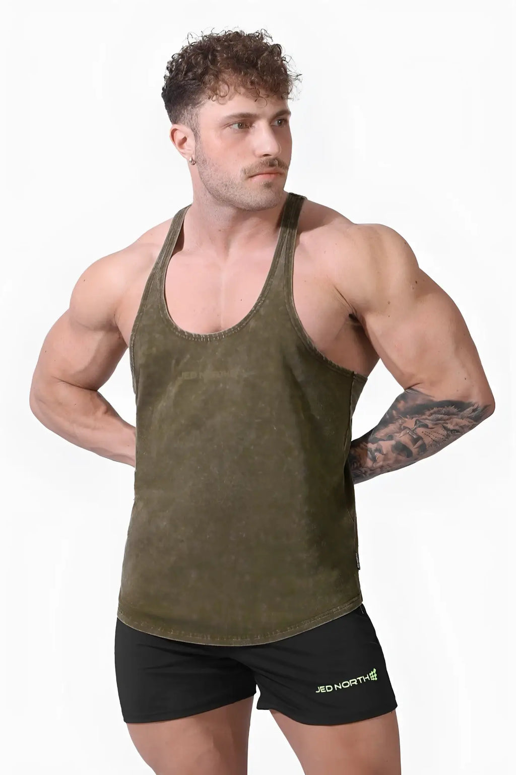 Classic vintage washed racerback stringer in hunter green cotton with a worn texture and minimal design