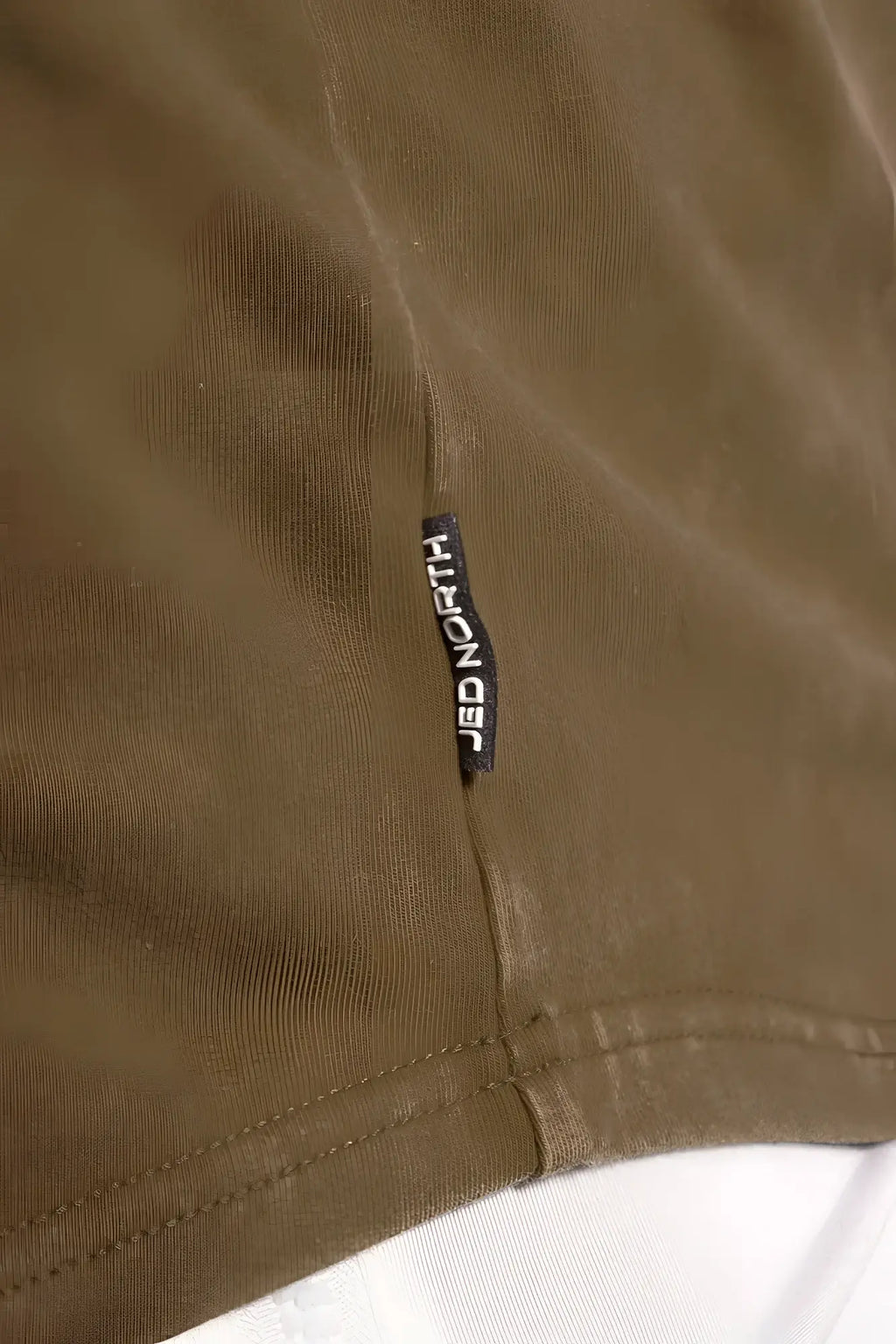 Olive green cotton classic vintage washed racerback stringer with black jed north brand tag stitched on seam