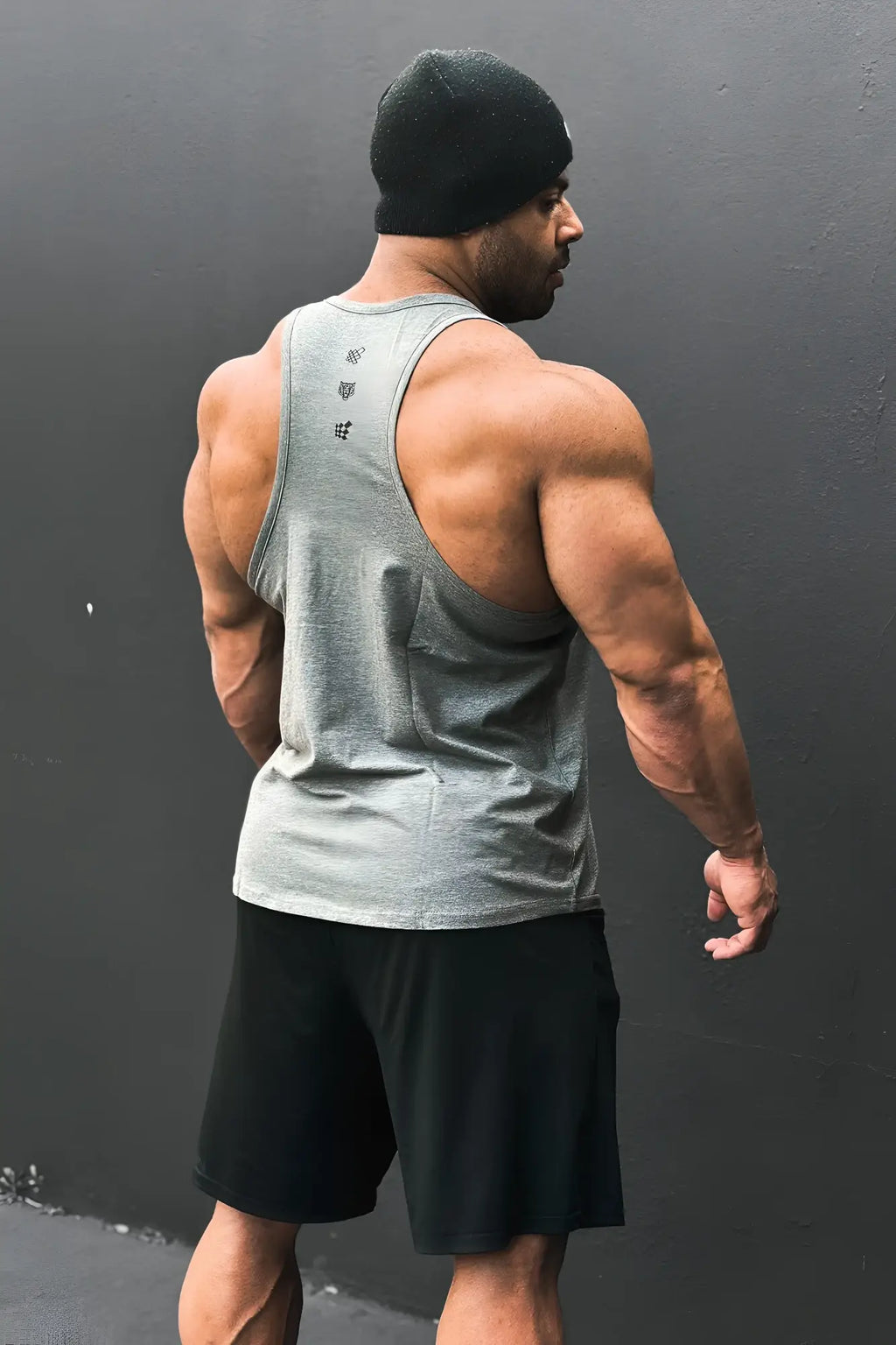 Back view of gray cotton training stringer tank top with subtle black logo detailing for athletic use