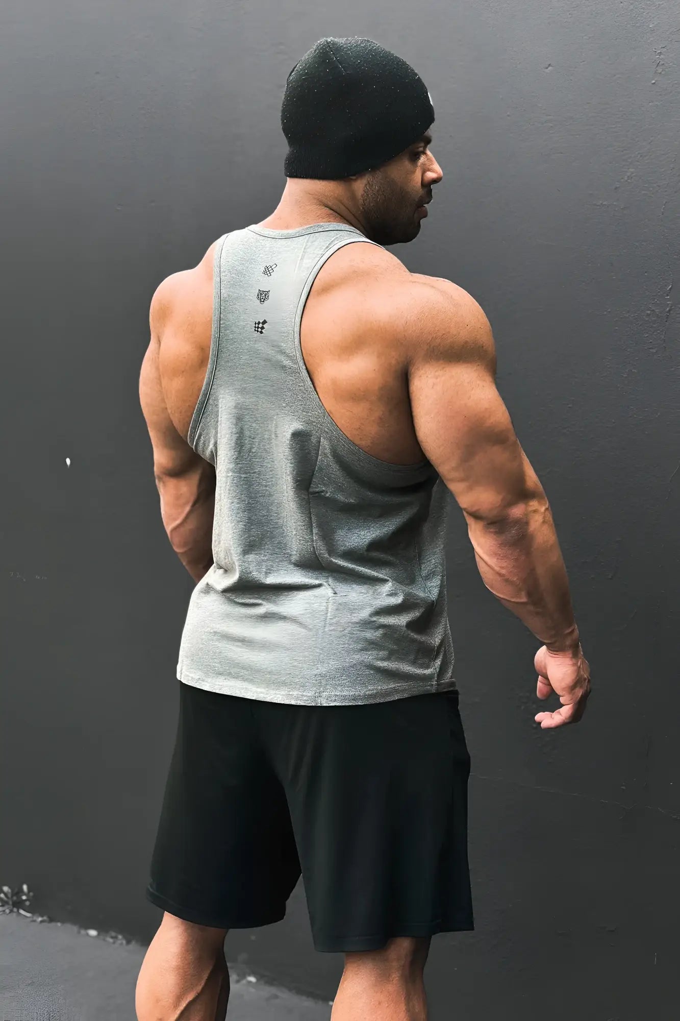 Back view of gray cotton training stringer tank top with subtle black logo detailing for athletic use