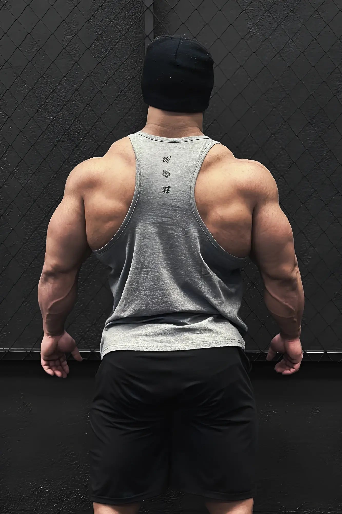 Back view of cotton training stringer heather gray muscle tank top with subtle logo and heathered texture