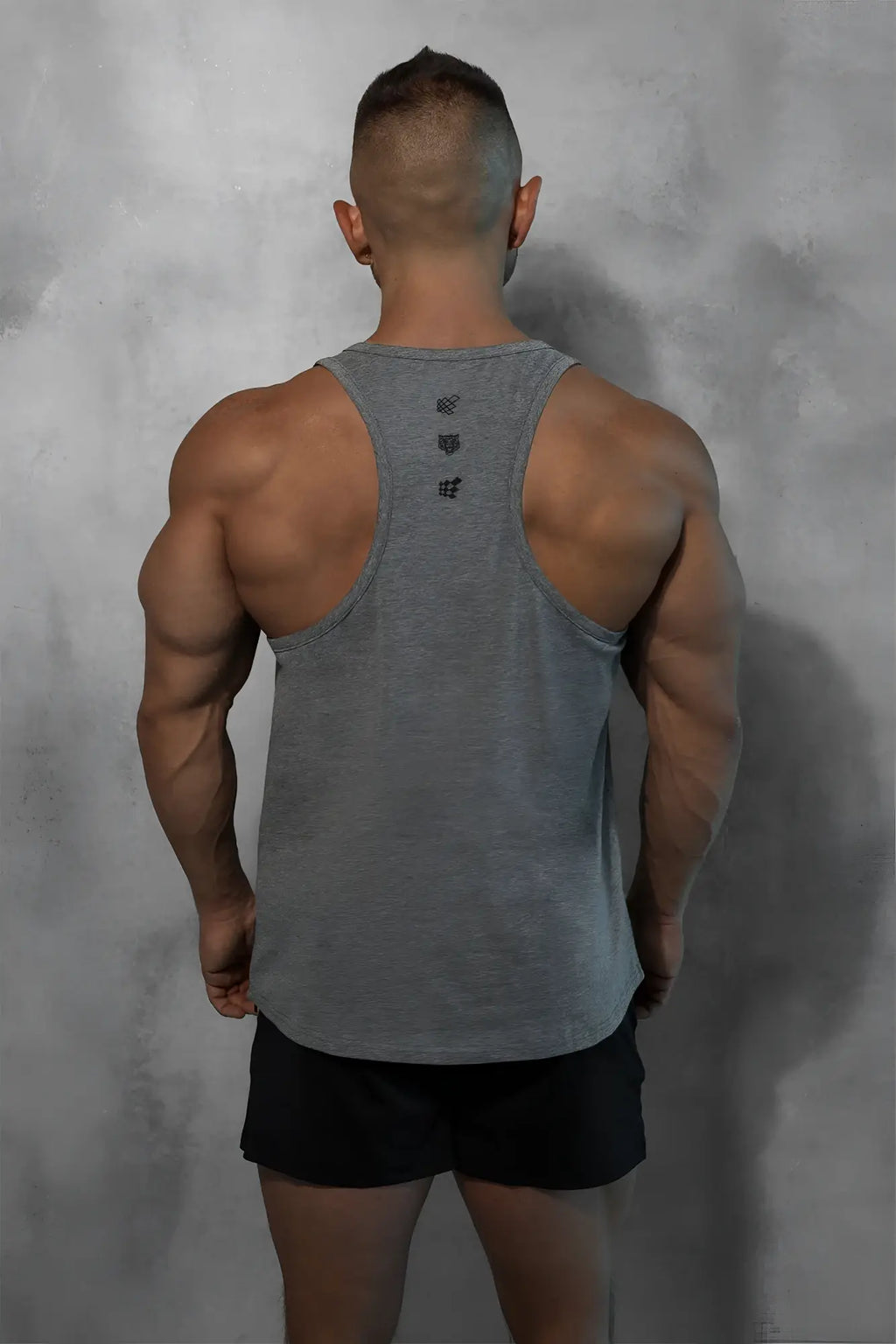Back view of a cotton training stringer muscle tank top in heather gray with subtle logo detail at the back
