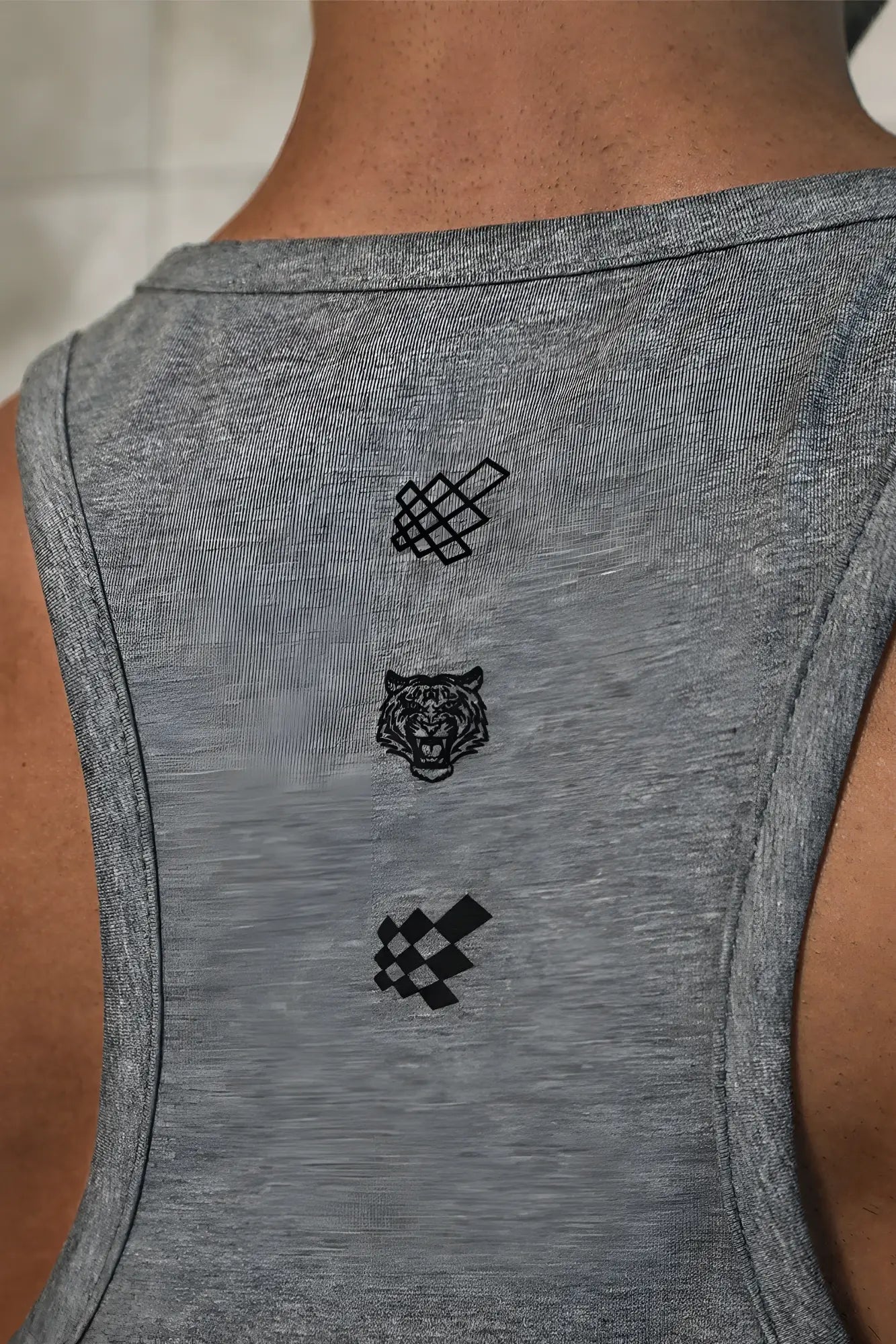 Back view of cotton training stringer heather gray muscle tank with three black embroidered designs on the back