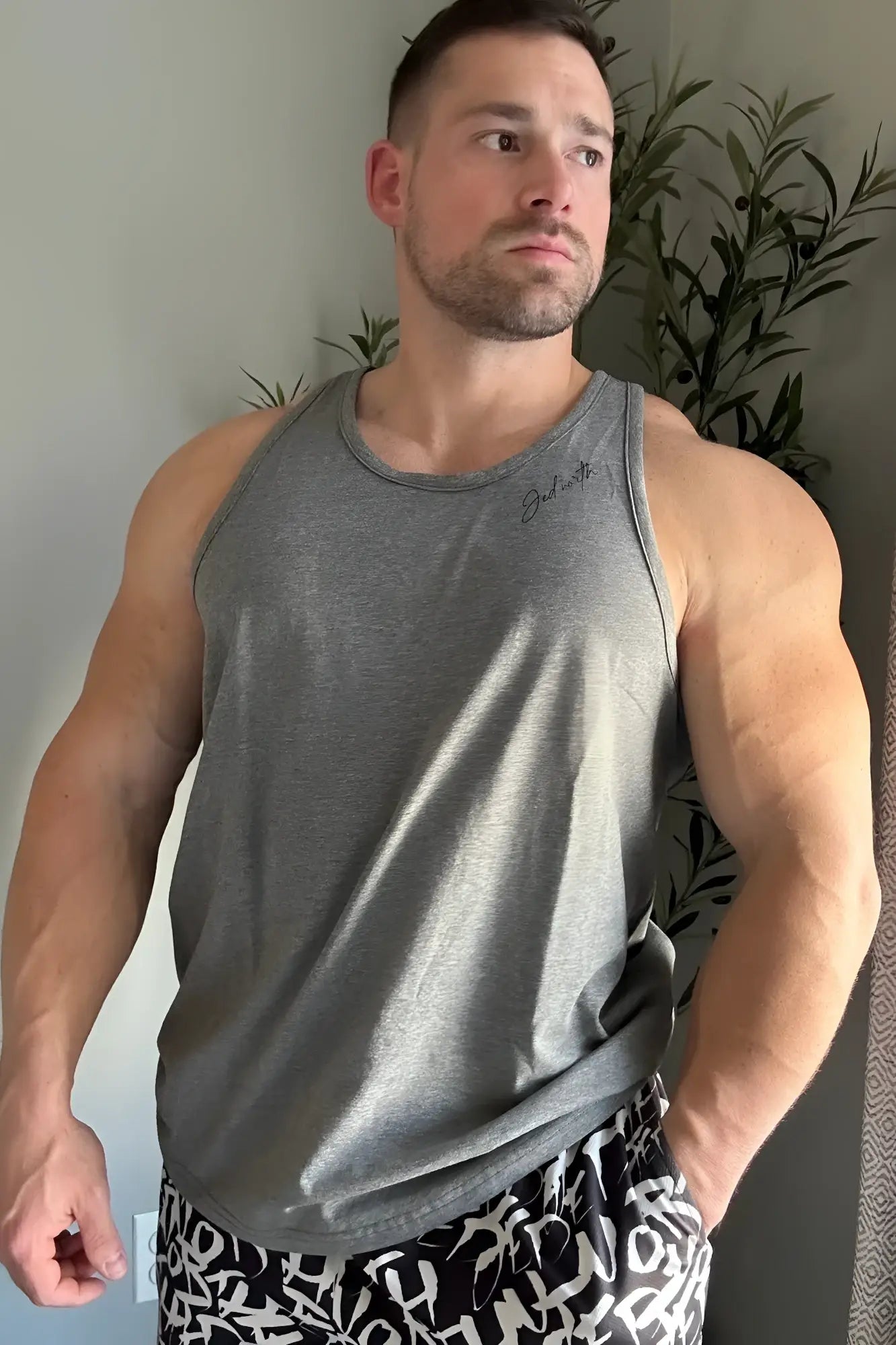 Gray heathered cotton training stringer tank top with subtle embroidered logo on the chest for workouts