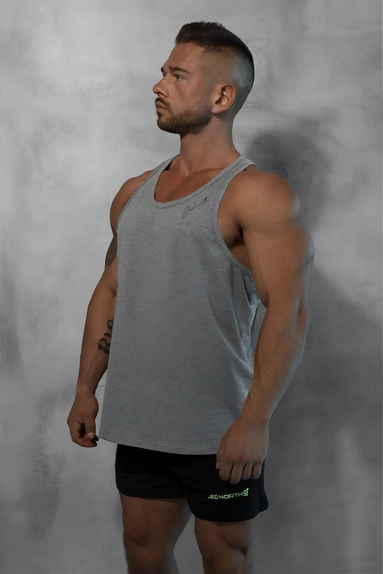Gray heathered cotton training stringer tank top with subtle embroidered logo on the chest