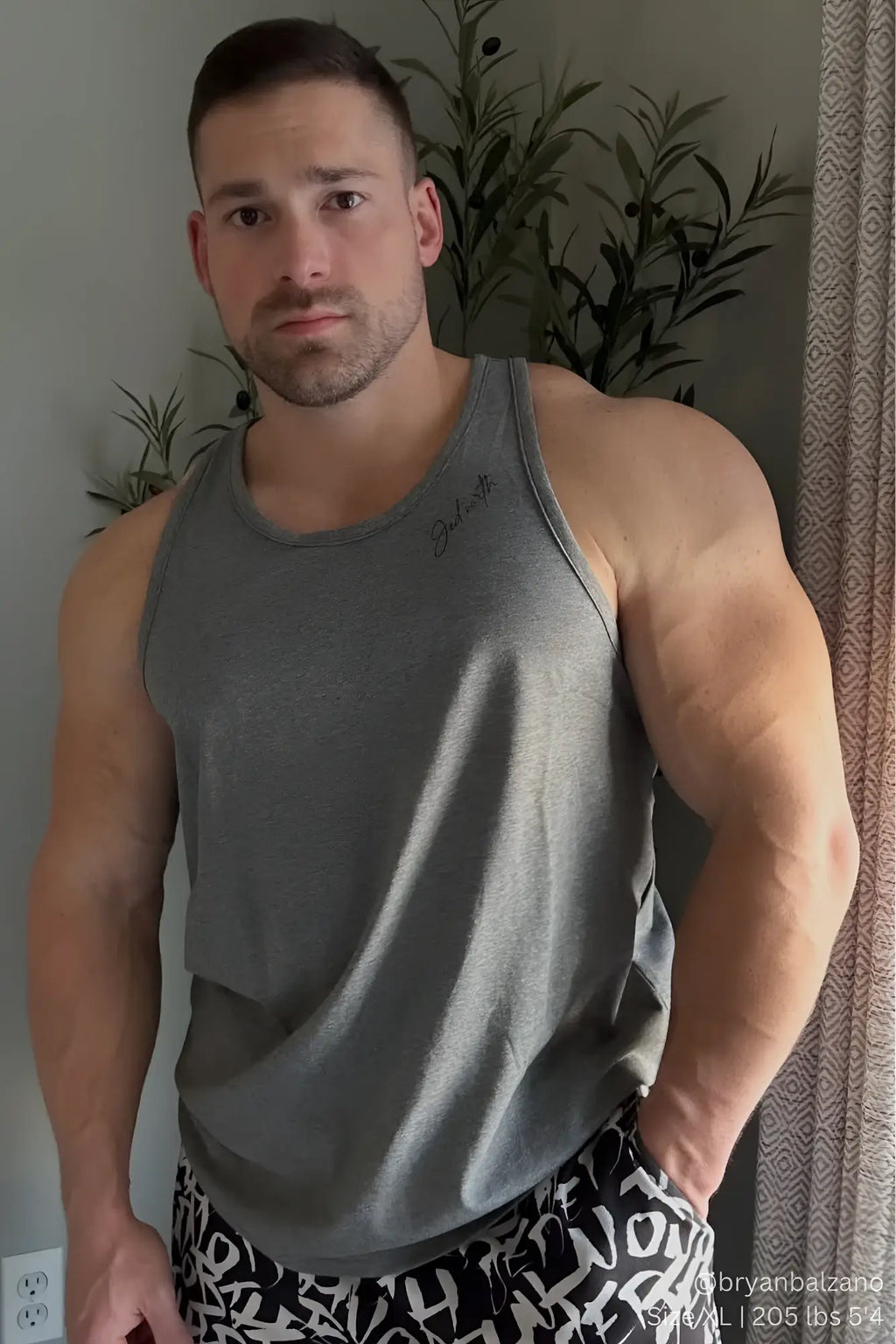 Gray heathered cotton training stringer tank top with subtle cursive logo on the left chest for workouts