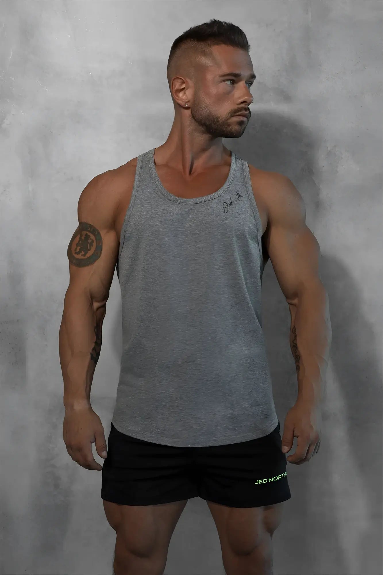 Gray heathered cotton training stringer tank top with subtle signature embroidery on the upper left chest