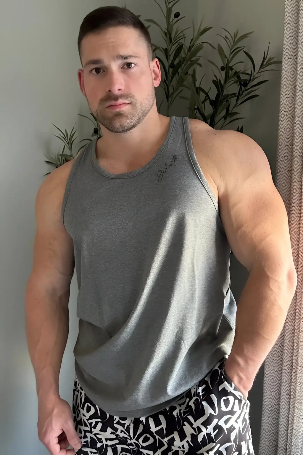 Gray heathered cotton training stringer tank top with subtle signature embroidery on the left chest for workouts