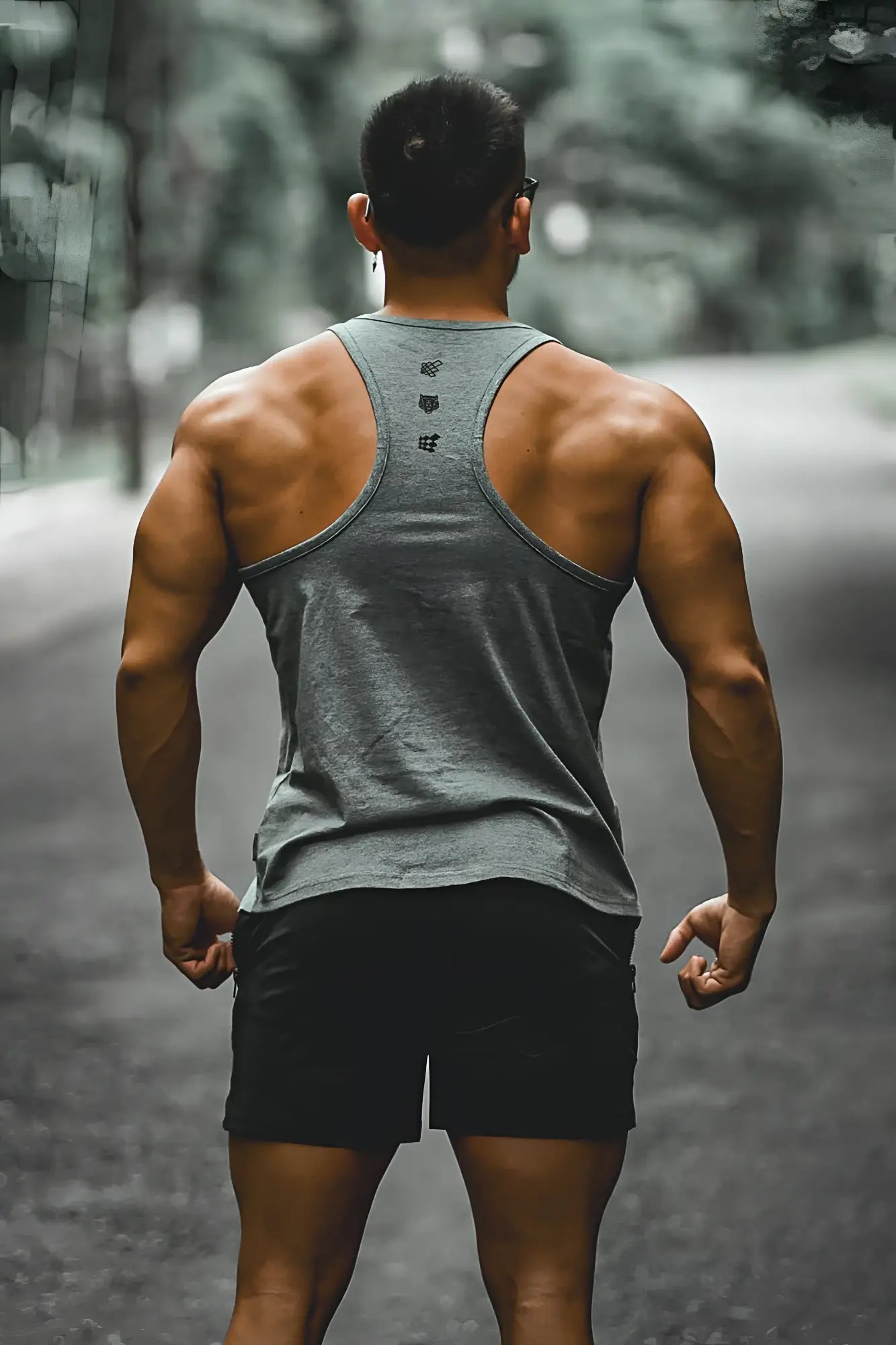 Back view of cotton training stringer gray racerback tank top with subtle black logo detailing on the back