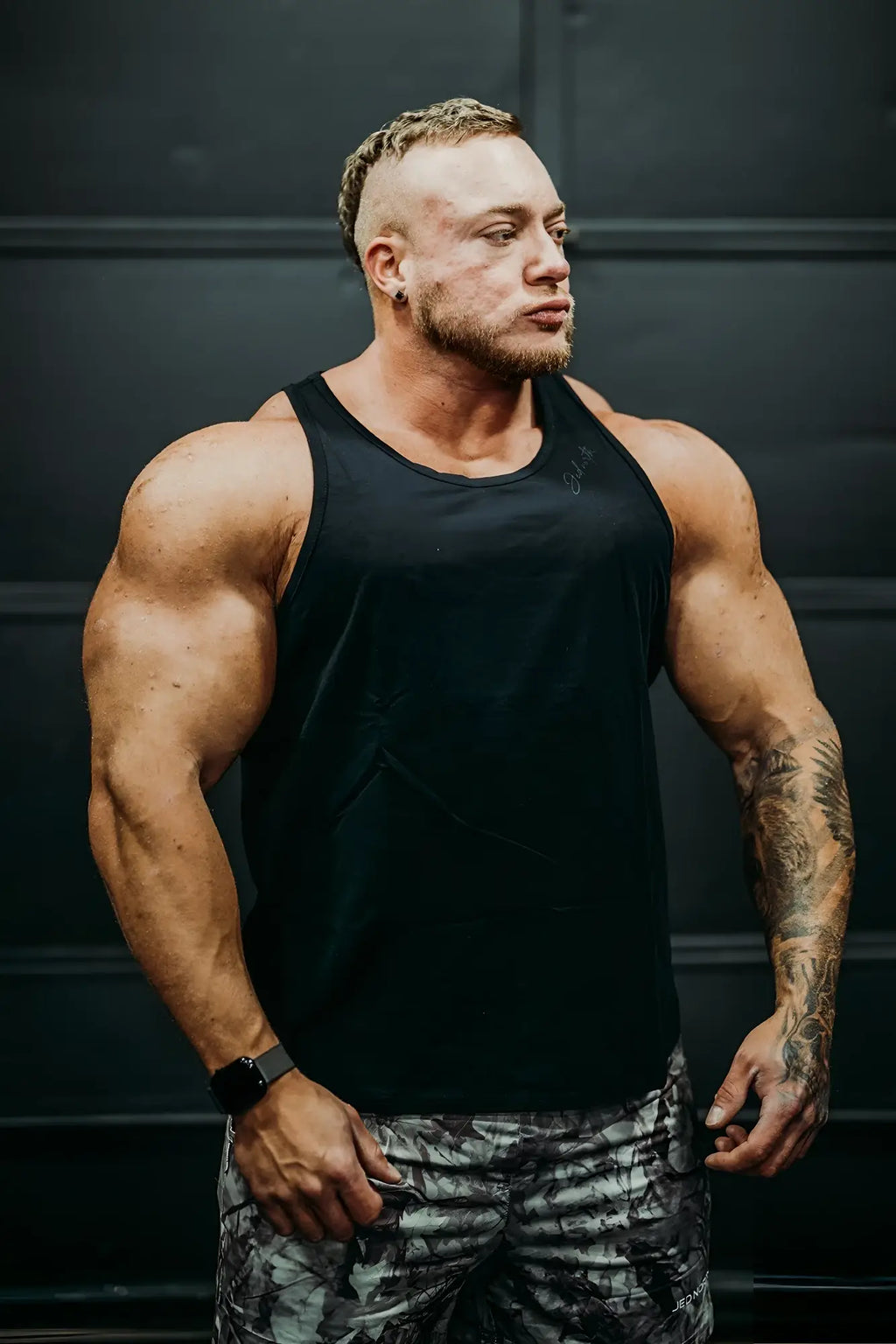 Black cotton training stringer tank top with subtle chest logo designed for workouts in midnight color
