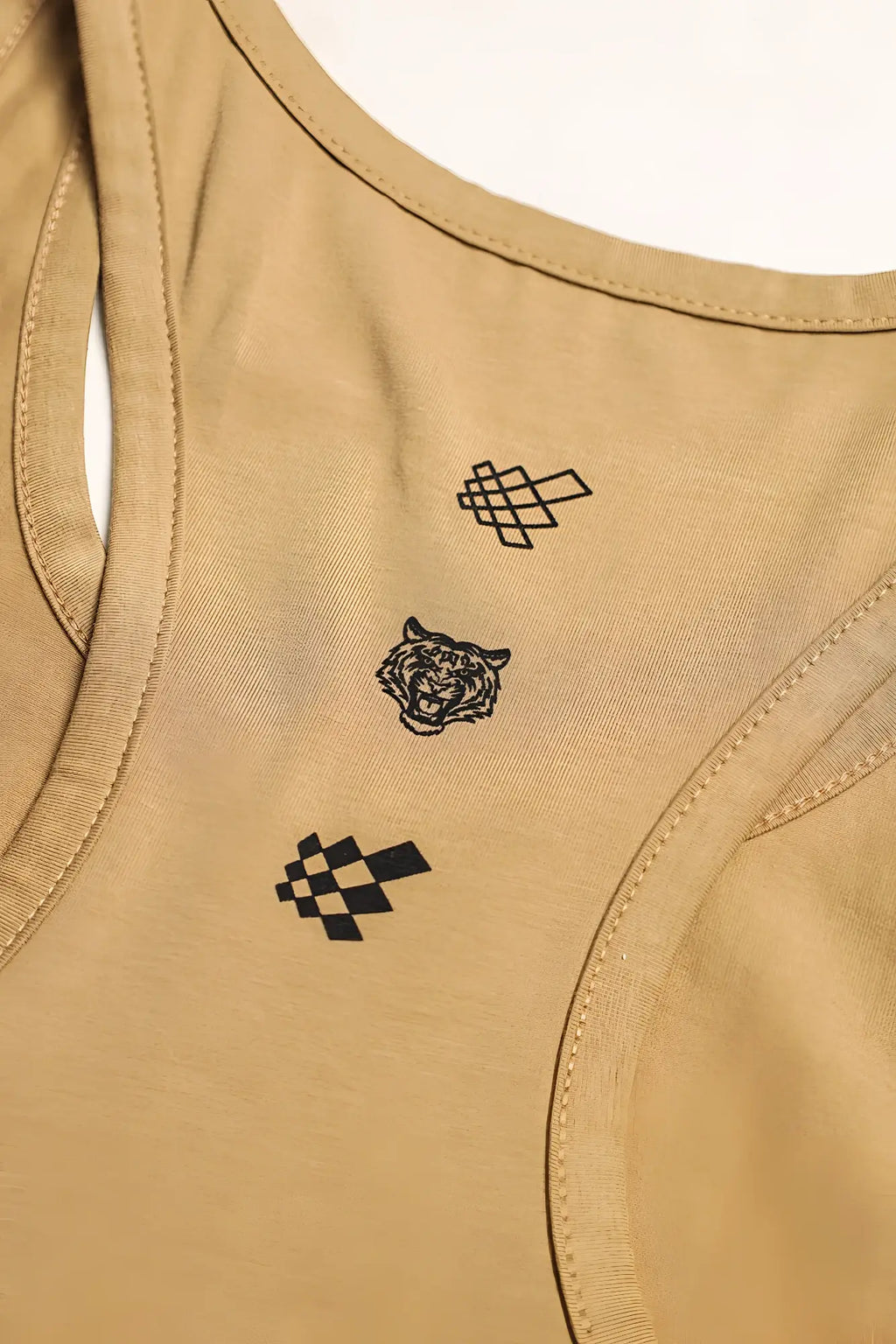 Tan cotton training stringer racerback tank top with black embroidered tiger and geometric pixel-style designs on back