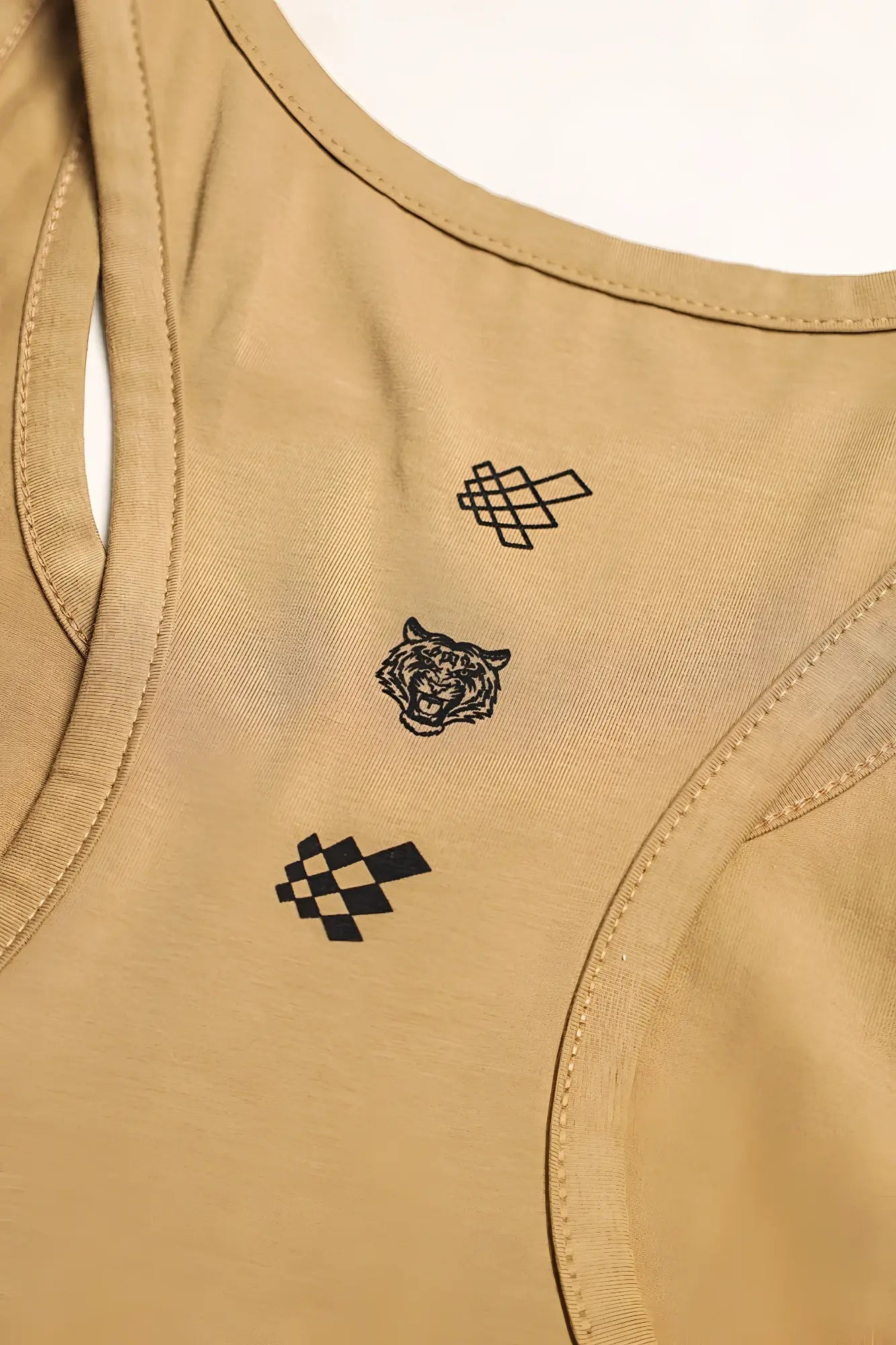 Tan cotton training stringer racerback tank top with black embroidered tiger and geometric pixel-style designs on back