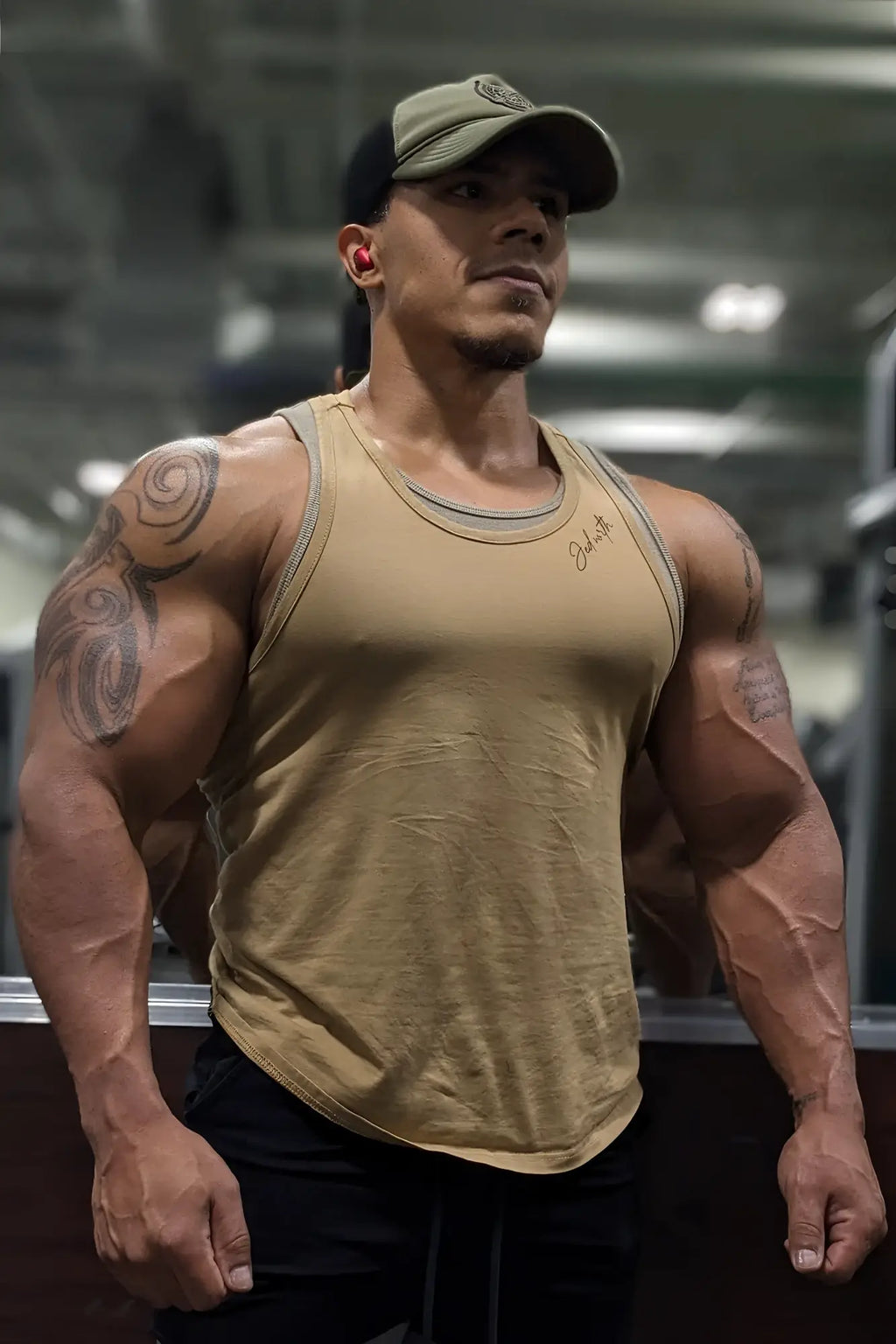 A tan cotton training stringer tank top with ribbed neckline and subtle gray trim for athletic use