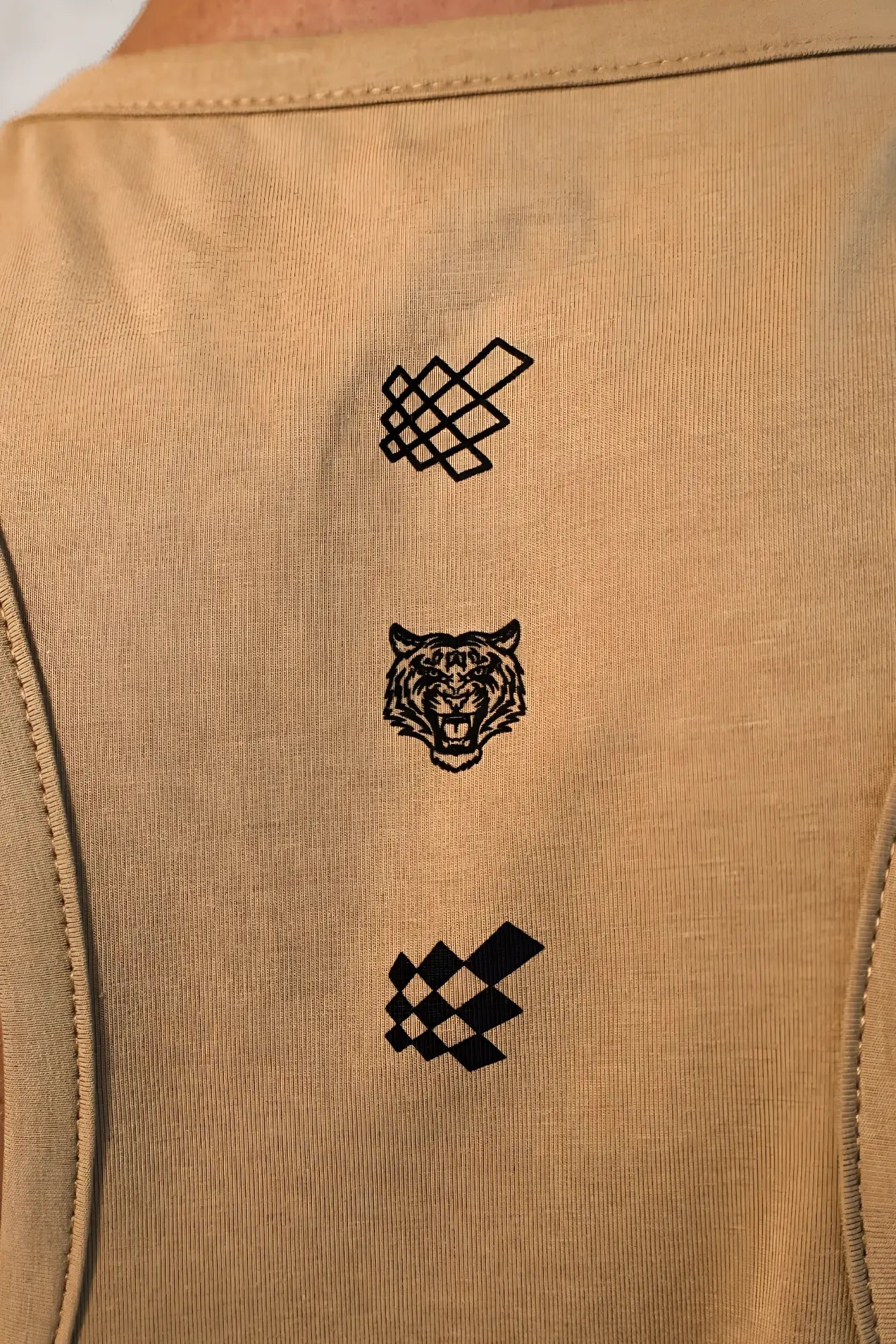 Tan cotton training stringer tank top with black embroidered geometric pattern tiger head and checkered flag logos