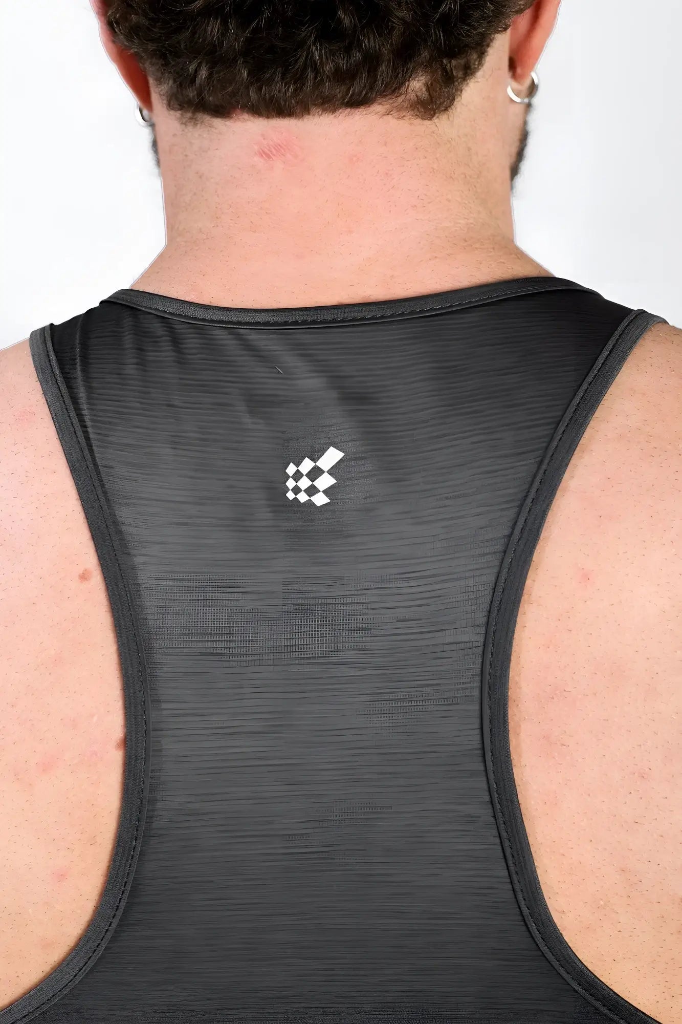 Back view of jed north dynamic bodybuilding stringer dark gray athletic tank top with textured fabric and white logo