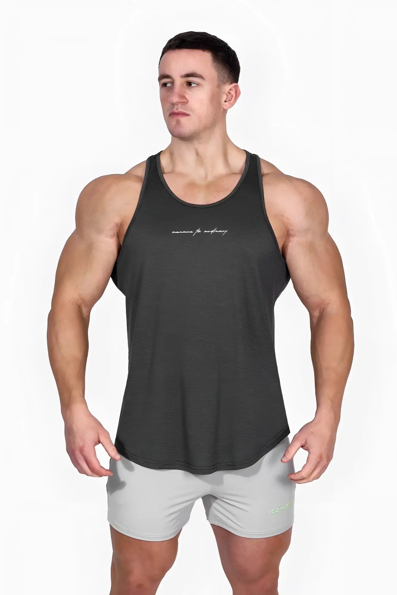 Dark gray jed north dynamic bodybuilding stringer muscle tank top with subtle white cursive lettering across the chest