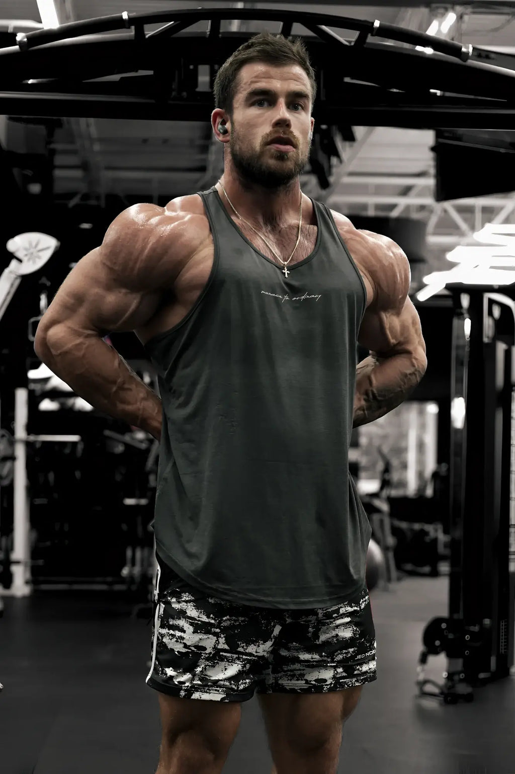 Dark gray sleeveless tank top with subtle embroidered logo across the chest by jed north for bodybuilding use
