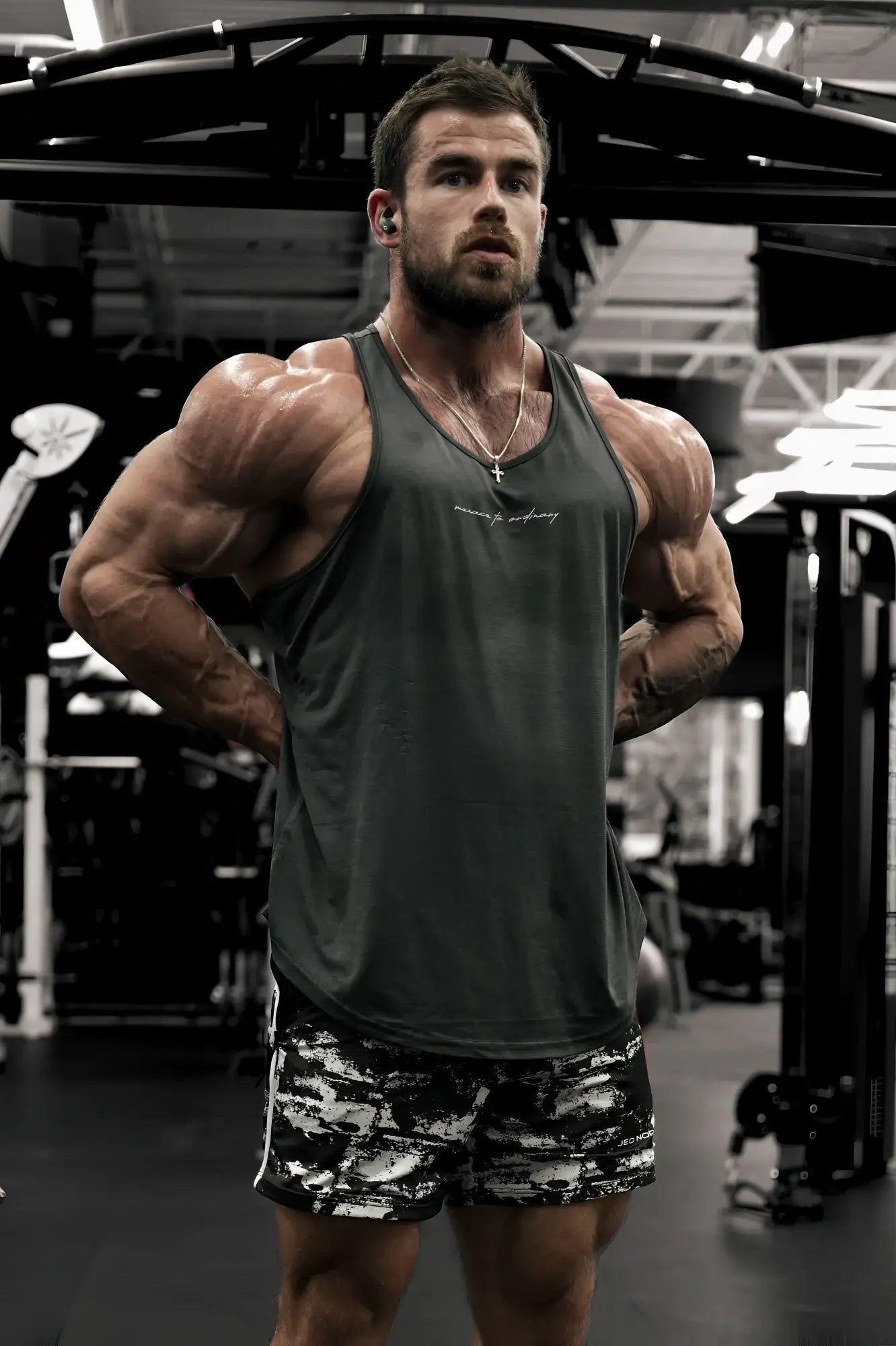 Dark gray sleeveless tank top with subtle embroidered logo across the chest by jed north for bodybuilding use