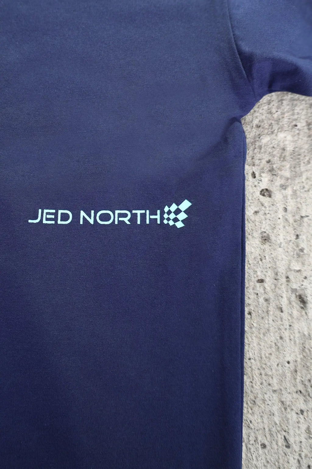 Midnight blue dark blue cotton jed north energy oversized long sleeve t-shirt with light teal embroidery and checkered logo