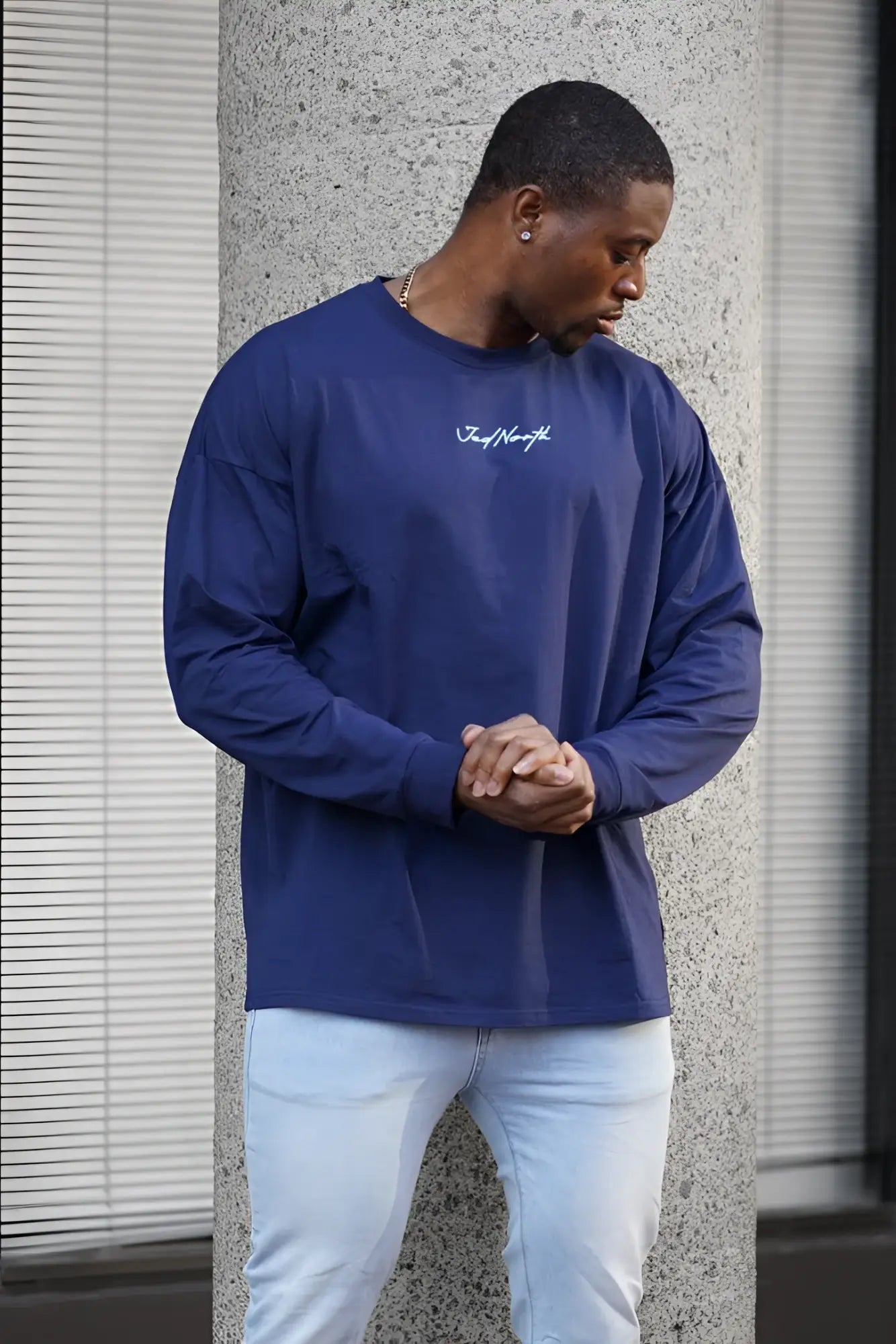 Navy blue jed north energy oversized long sleeve t-shirt with white cursive logo on the chest in crewneck style