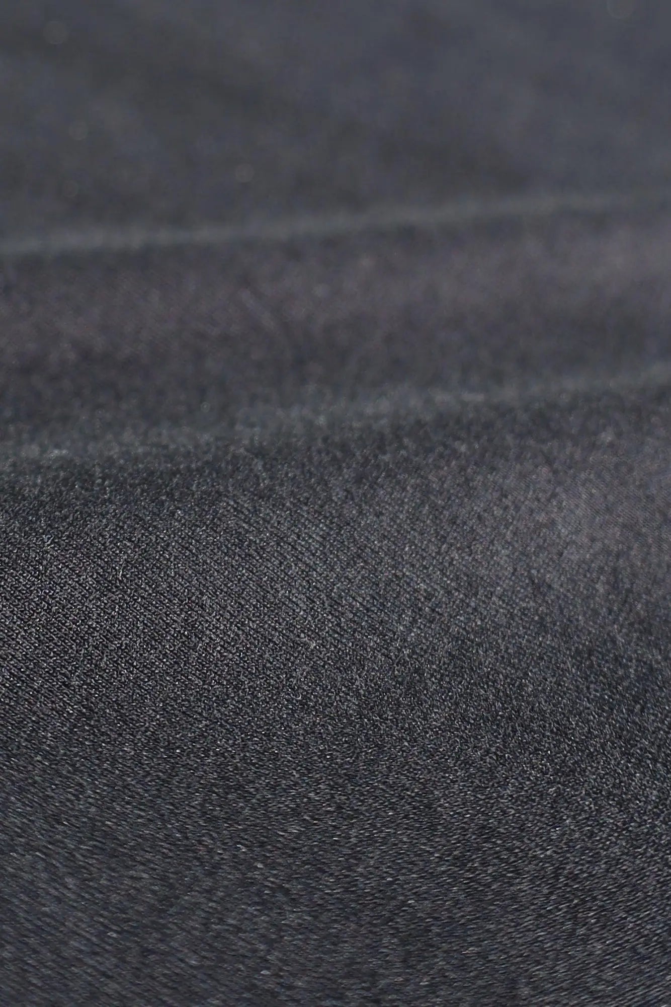 Jed north energy oversized long sleeve t-shirt 2.0 obsidian black made of dark gray denim fabric with a textured worn surface