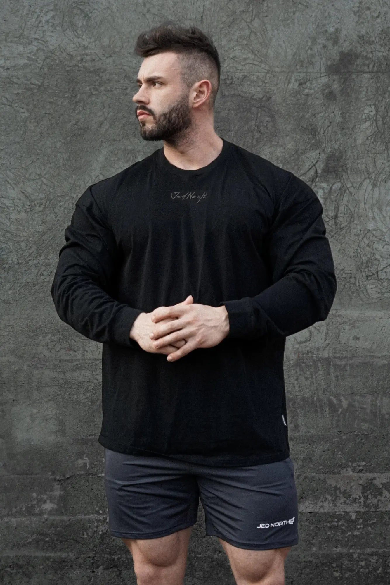 Jed north energy oversized long sleeve t shirt 2.0 in obsidian black with subtle white cursive logo on the chest and hem tag