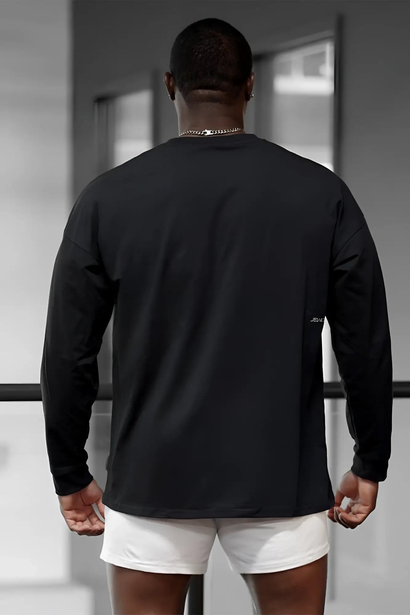 Jed North energy oversized long sleeve t-shirt 2.0 in obsidian black with subtle logo on the left sleeve, ideal for workouts