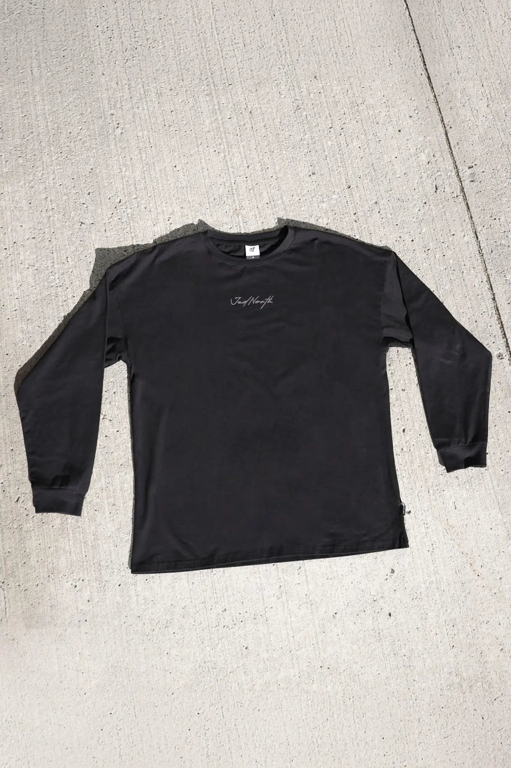 Black Jed North Energy oversized long sleeve t-shirt with subtle white cursive logo on the chest in obsidian black