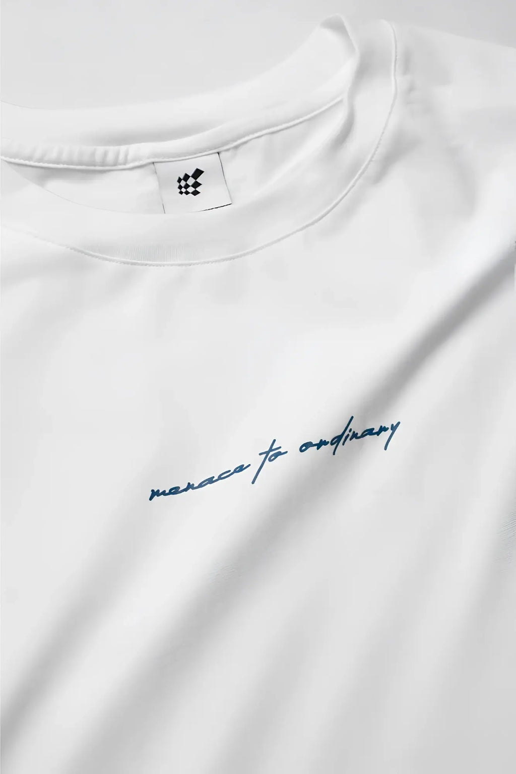 Energy oversized cream cotton t-shirt with subtle blue cursive embroidery reading merace to ordinary across chest