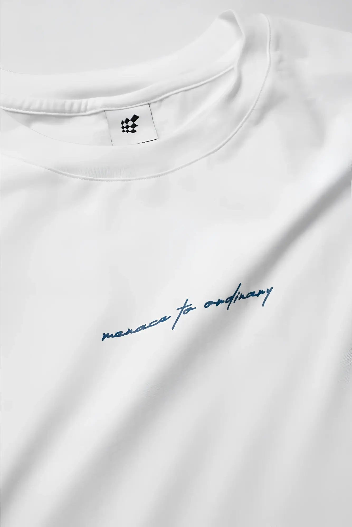 Energy oversized cream cotton t-shirt with subtle blue cursive embroidery reading merace to ordinary across chest