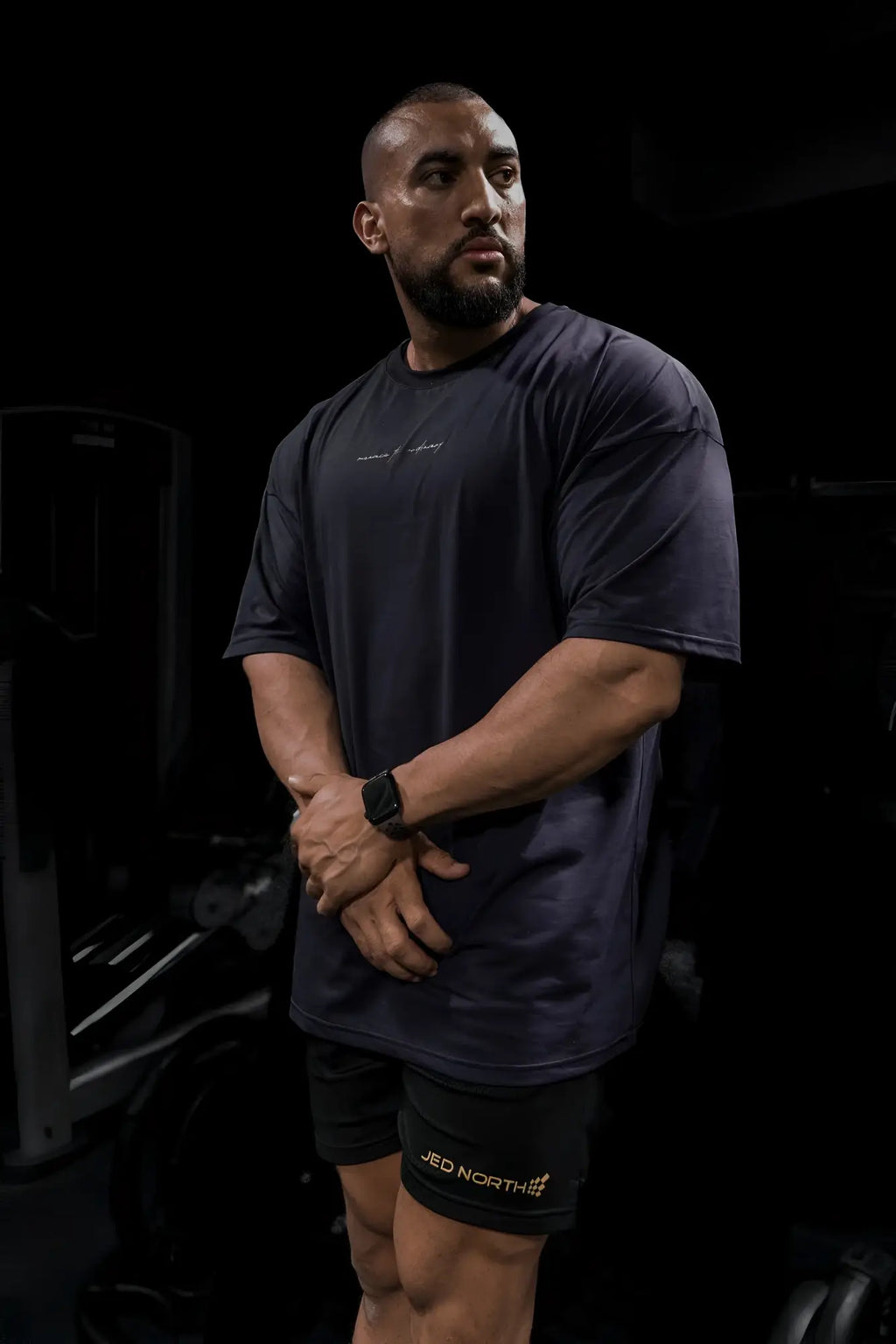 Dark navy blue short-sleeved jed north energy oversized t-shirt with subtle white script logo across the chest