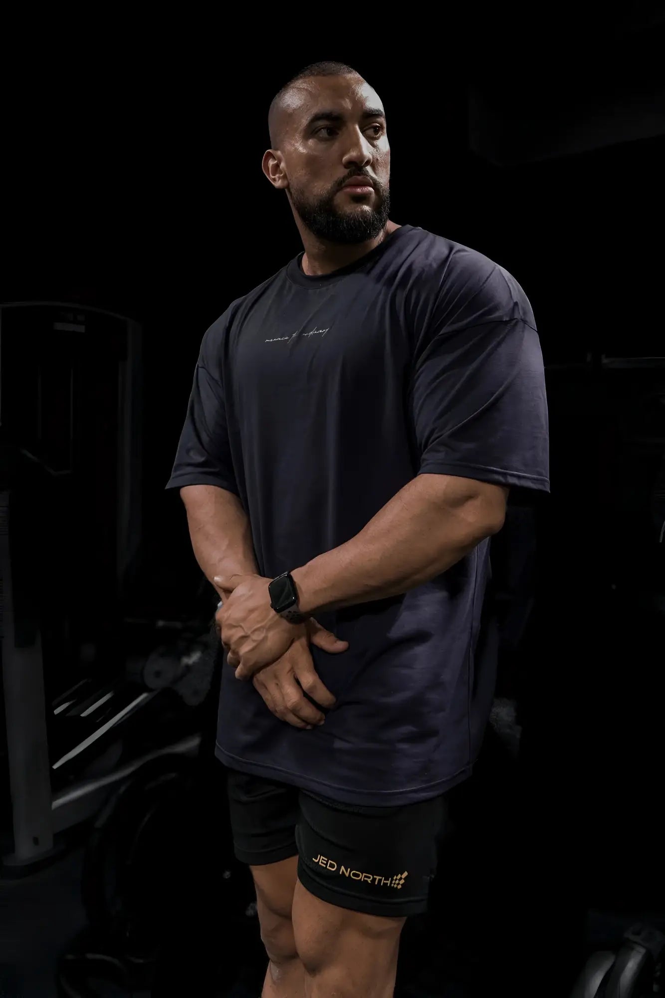 Dark navy blue short-sleeved jed north energy oversized t-shirt with subtle white script logo across the chest