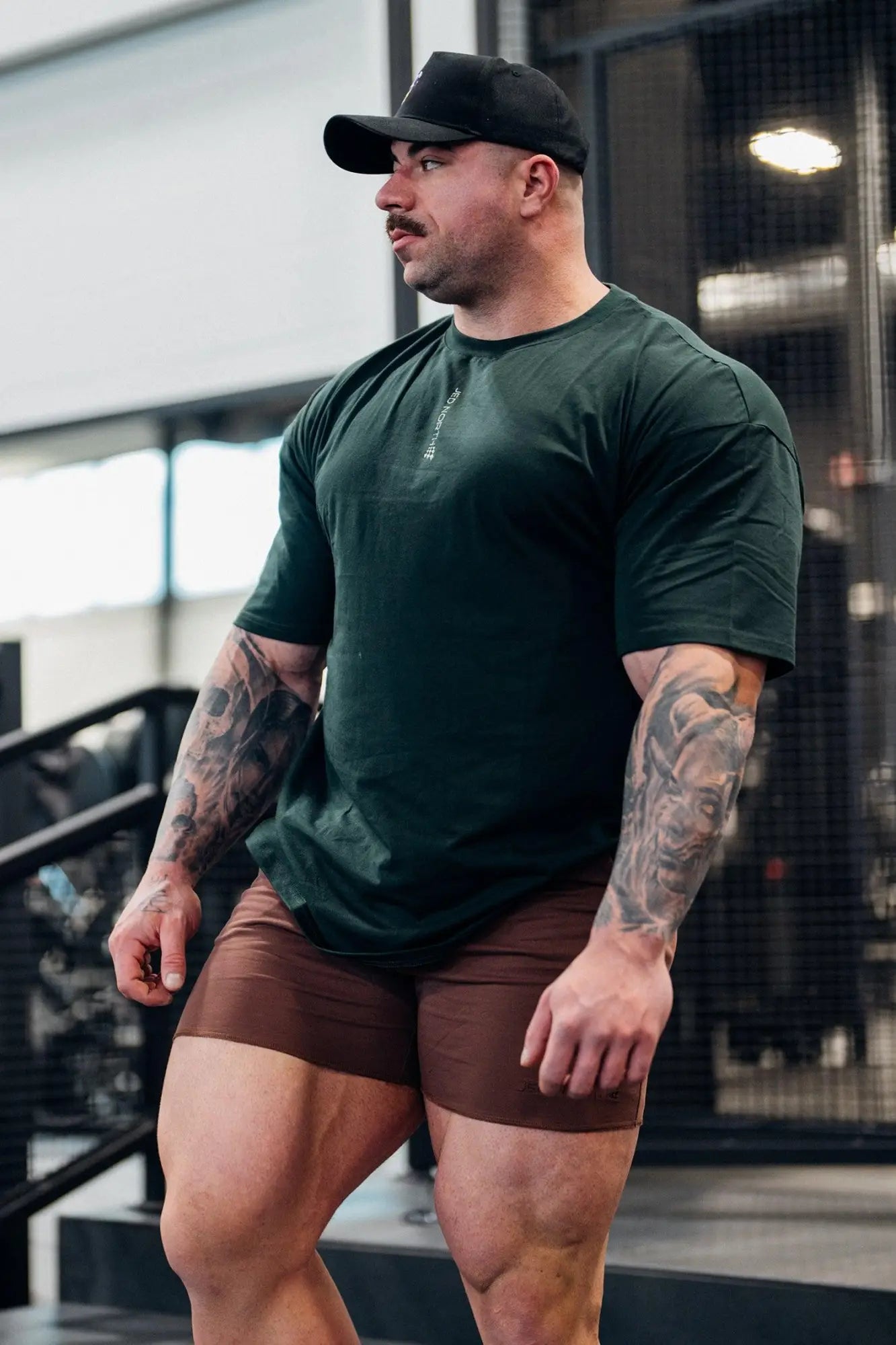 Dark green jed north energy oversized t-shirt with subtle vertical text on left chest area in soft cotton fabric