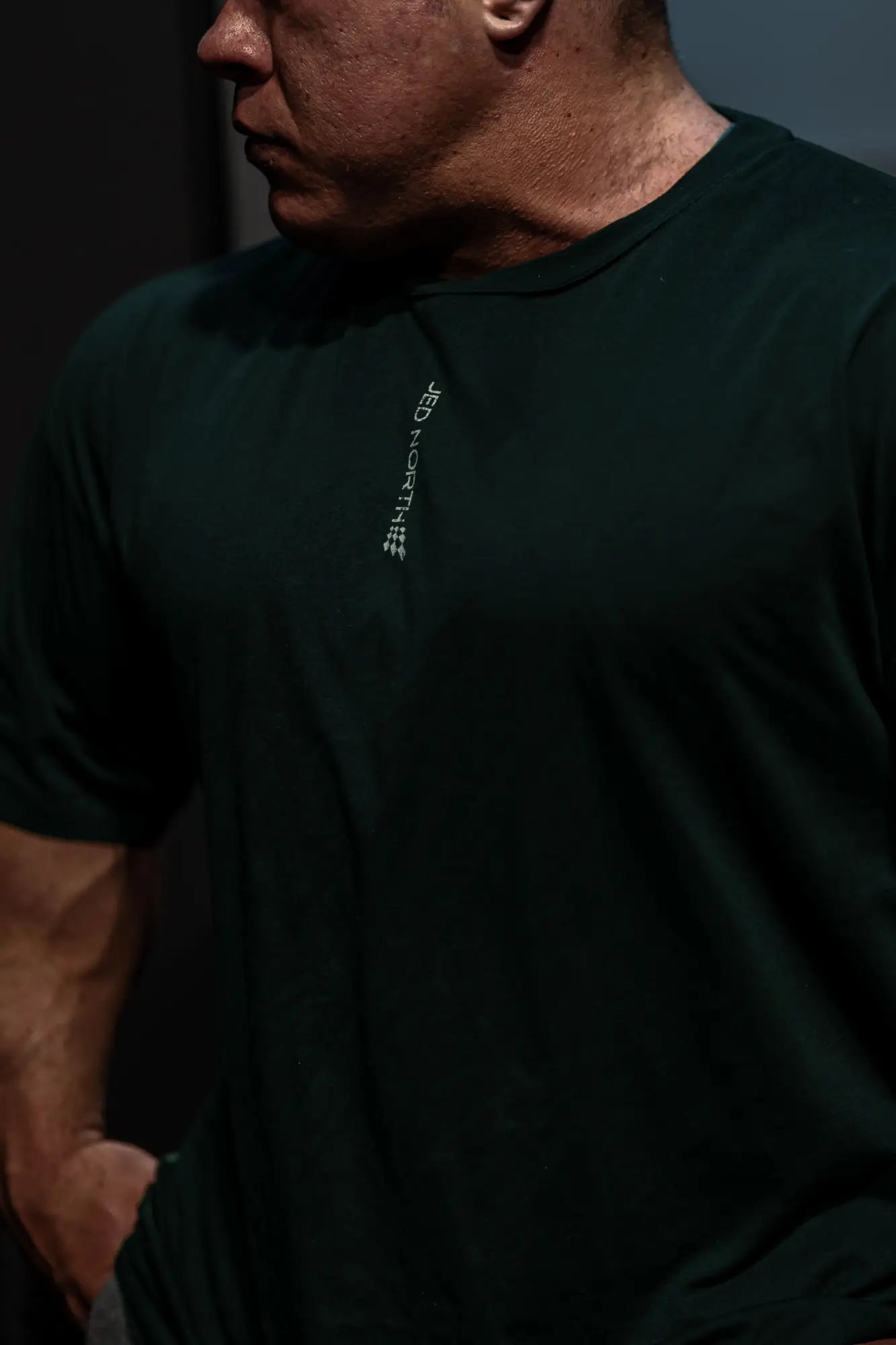 Jed North Energy oversized t-shirt in forest green with a dark green fabric and subtle white vertical logo on left chest