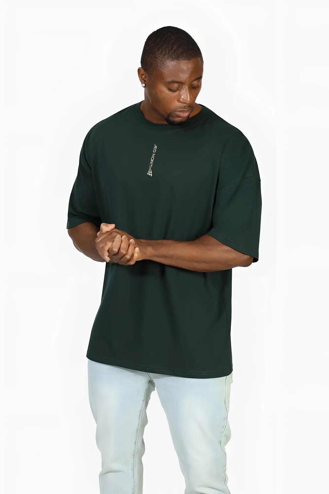 Dark green oversized Jed North Energy t-shirt featuring a small white vertical logo on the left chest