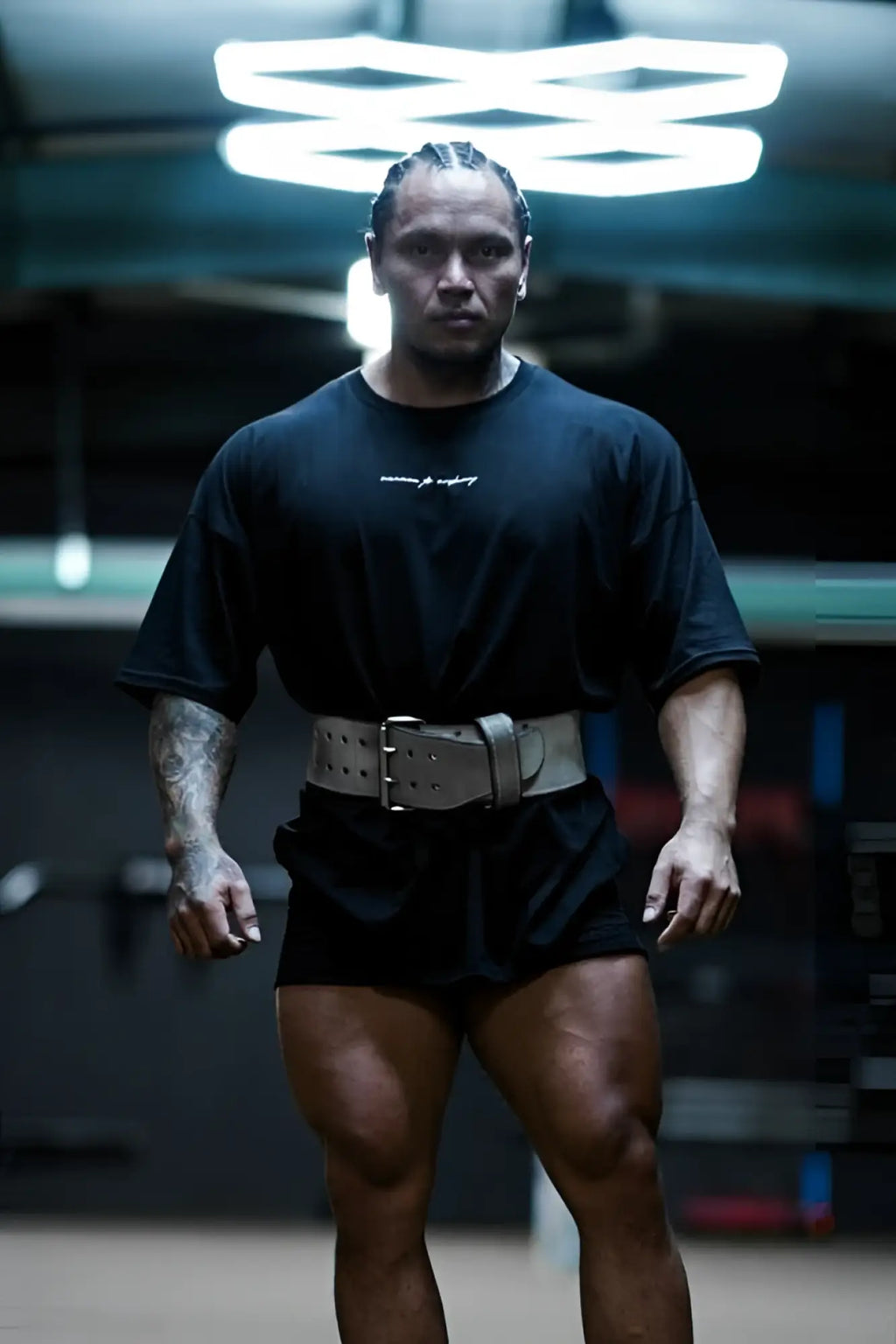 Black athletic belt with silver-toned buckle and multiple adjustment holes for jed north energy oversized t-shirt