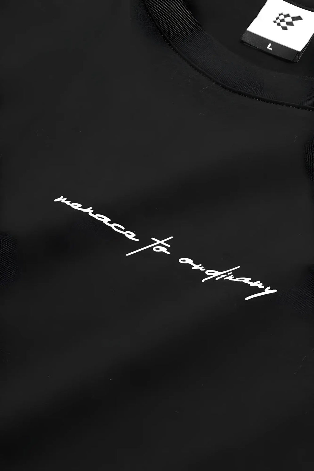 Black cotton jed north energy oversized t-shirt with white cursive embroidery reading menace to ordinary and size label