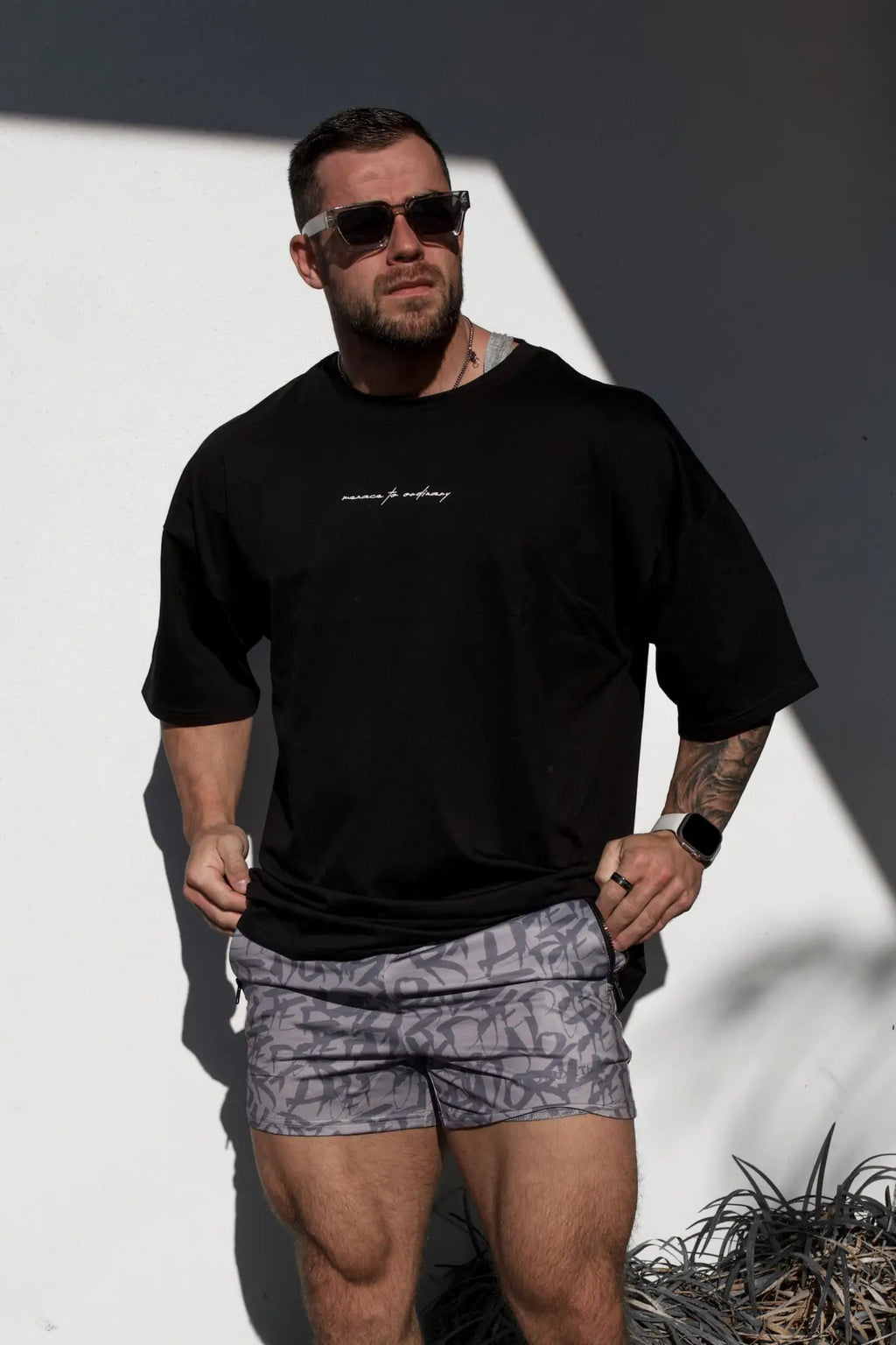 Black oversized Jed North Energy t-shirt for men with white cursive text across the chest in menace black color