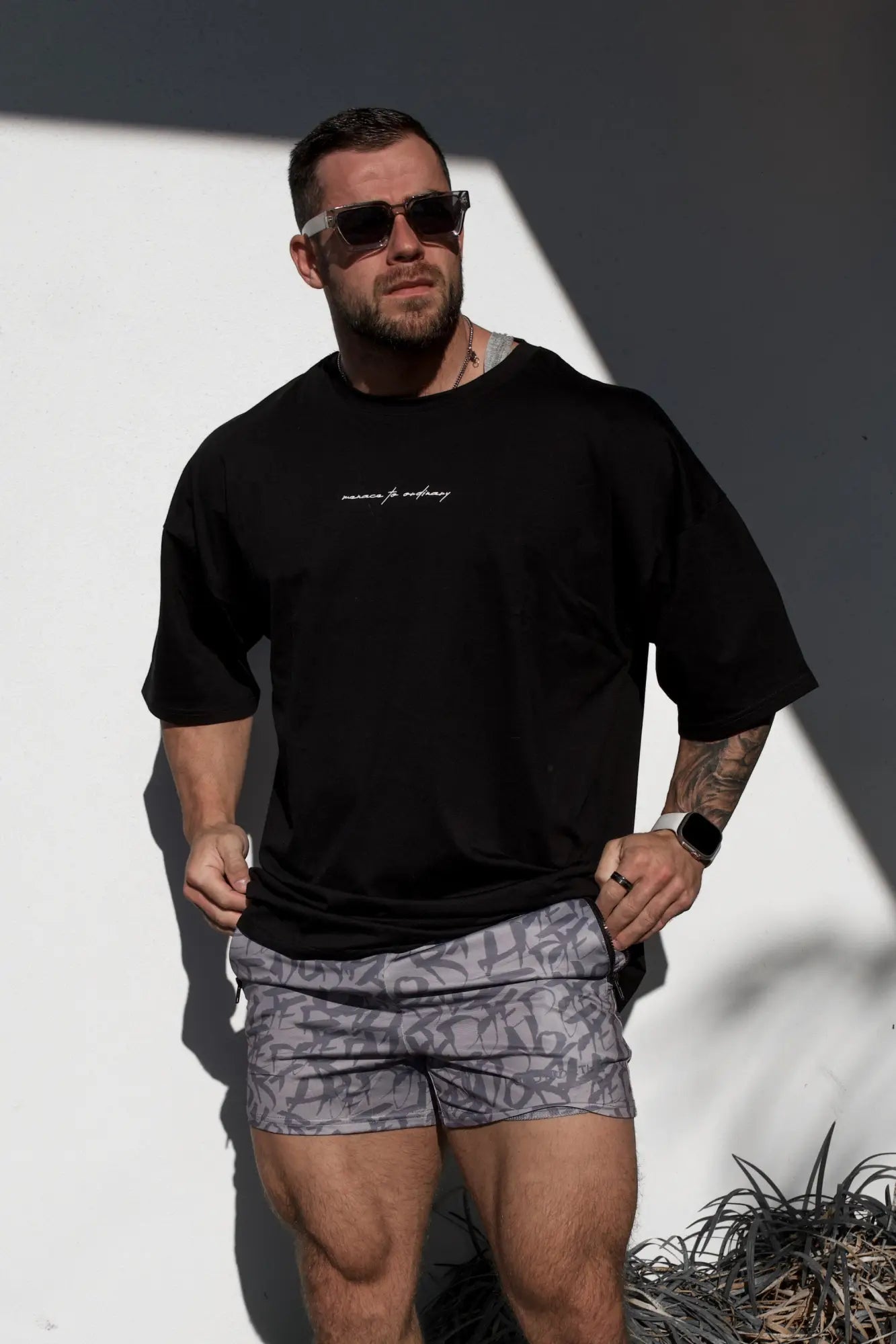 Black oversized Jed North Energy t-shirt for men with white cursive text across the chest in menace black color