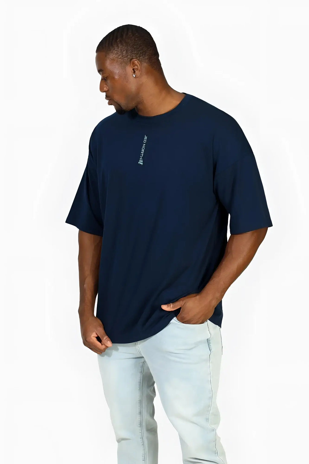 Navy blue oversized Jed North Energy t-shirt featuring a small white vertical logo on the left chest in cotton blend